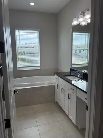 Master bathroom with vanity area and dee