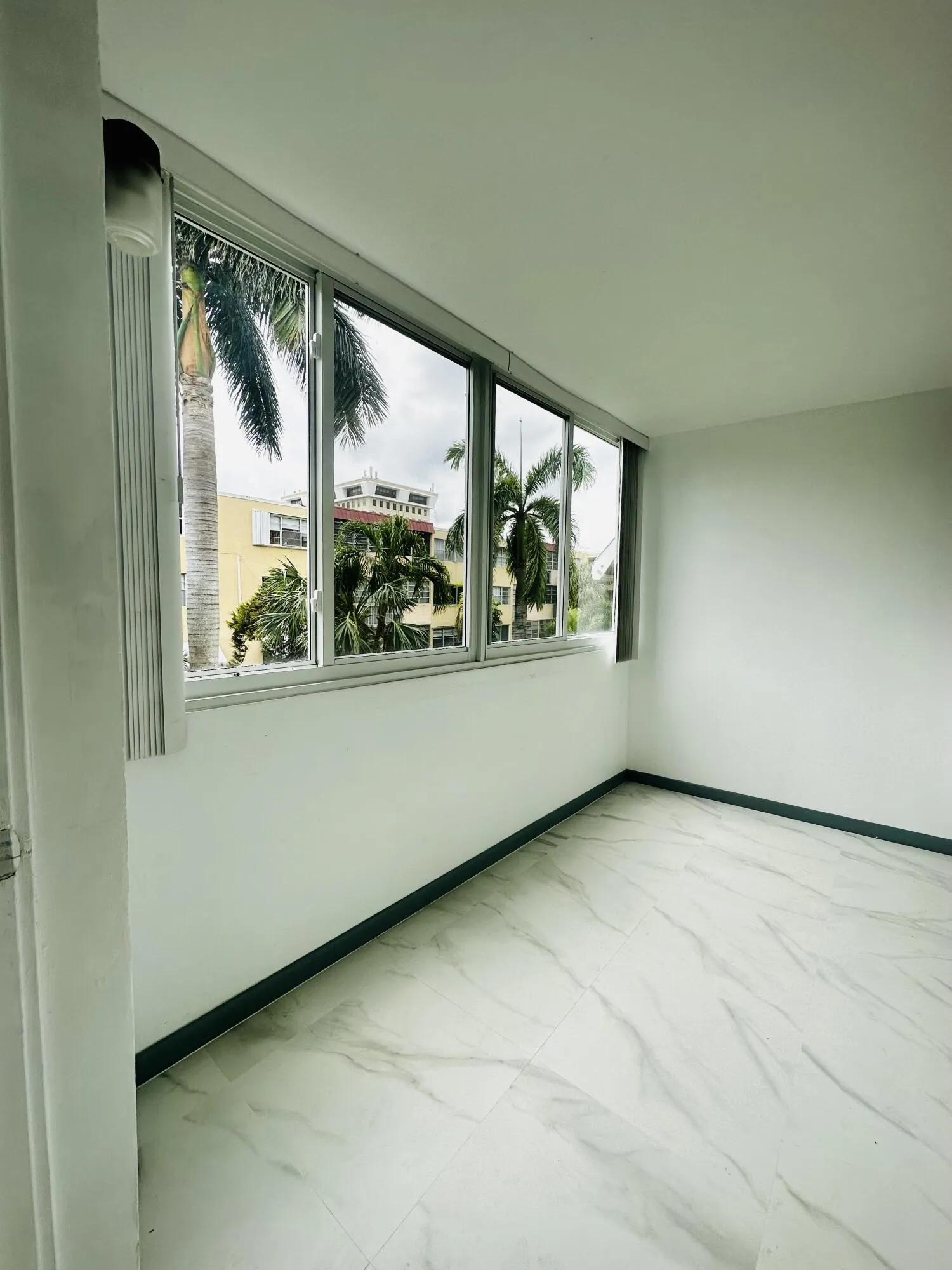 Enclosed balcony can be extra bedroom.