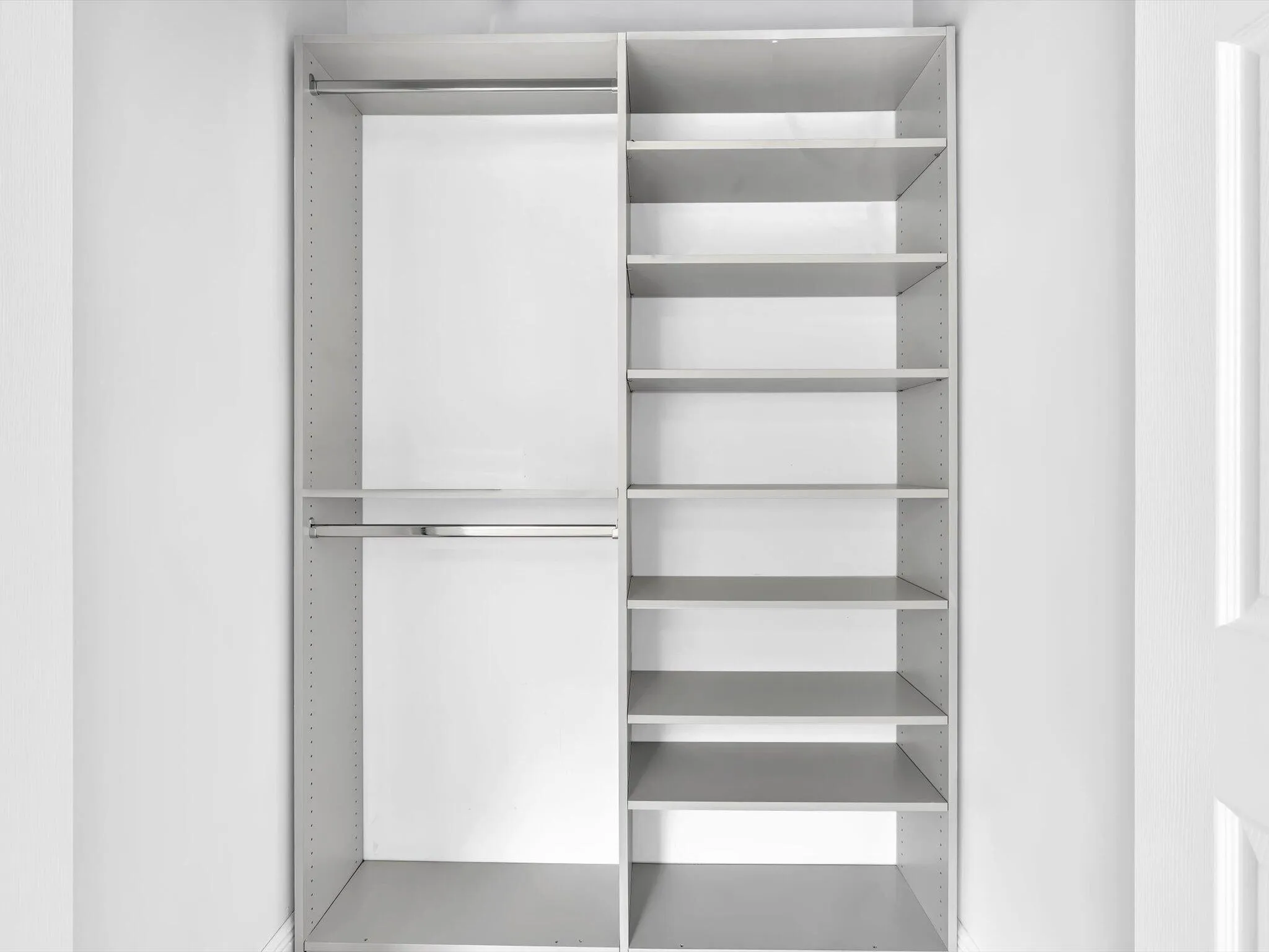 Built-in closet system featuring dual hanging rods and adjustable shelving