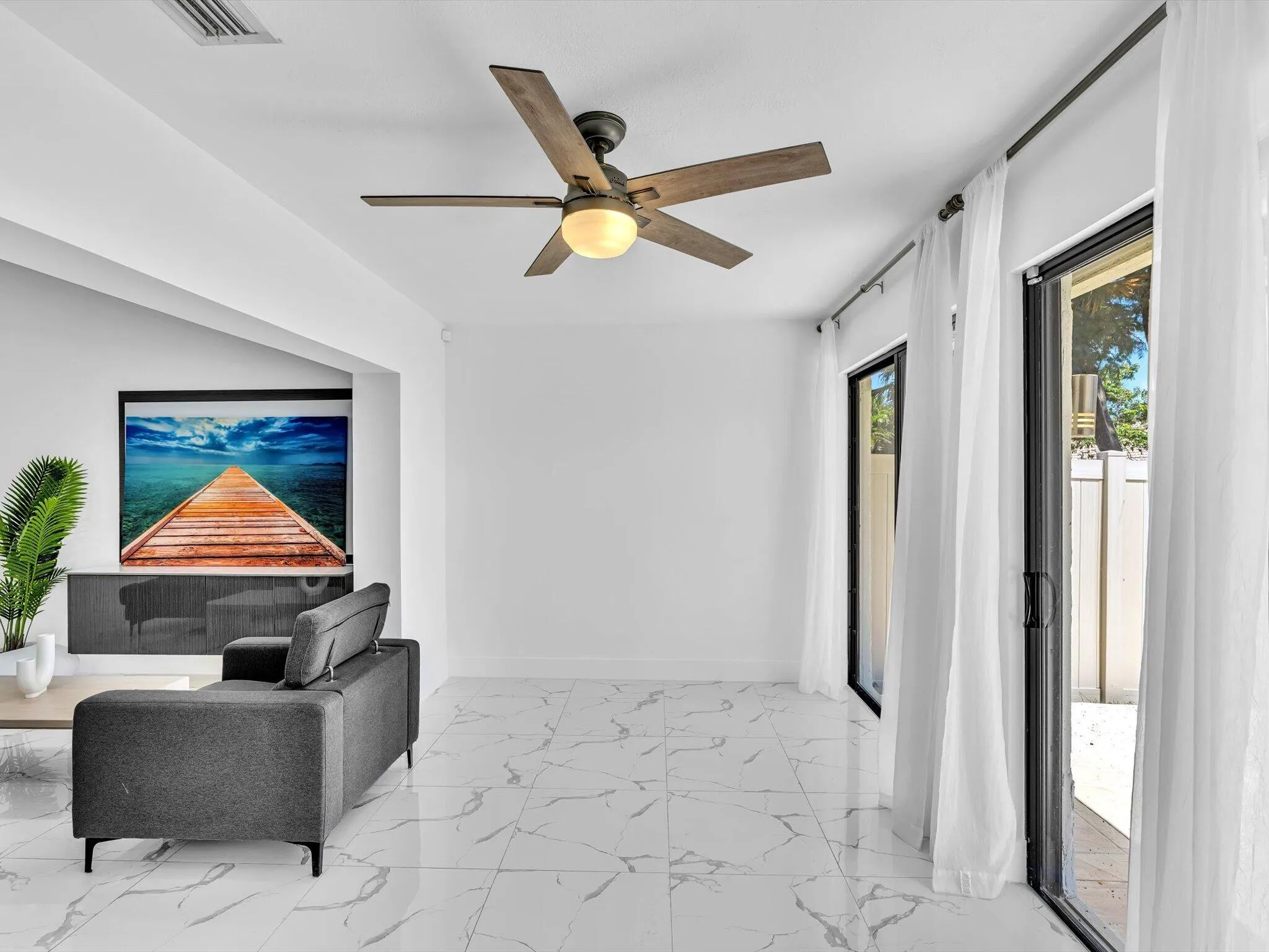 White tile flooring, recessed lighting, ceiling fan, and sliding glass doors