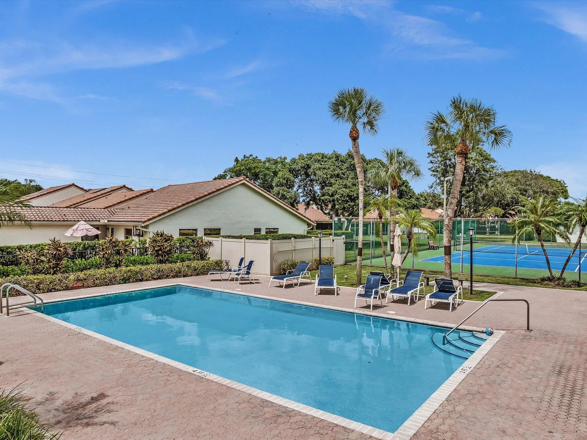 Outdoor swimming pool with integrated steps, surrounded by a paver deck