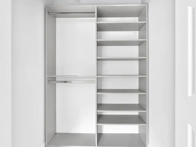 Built-in closet system featuring dual hanging rods and adjustable shelving