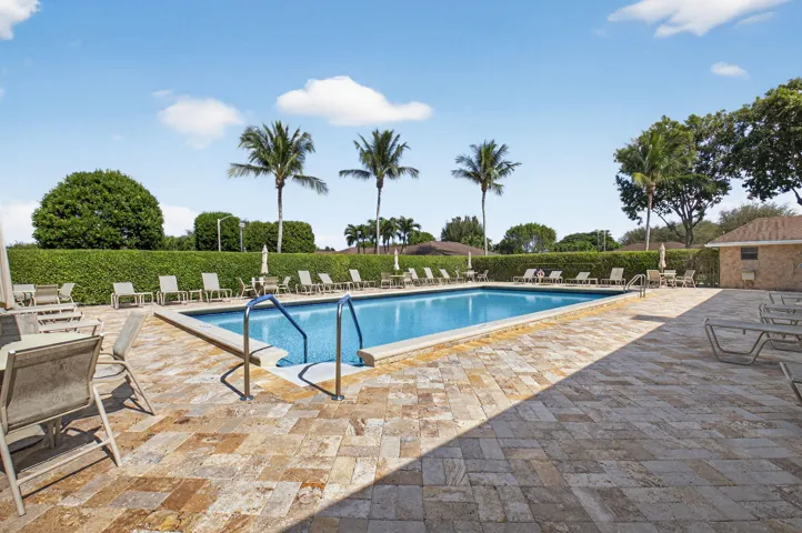 Rectangular swimming pool with tiled interior, surrounded by a paver deck