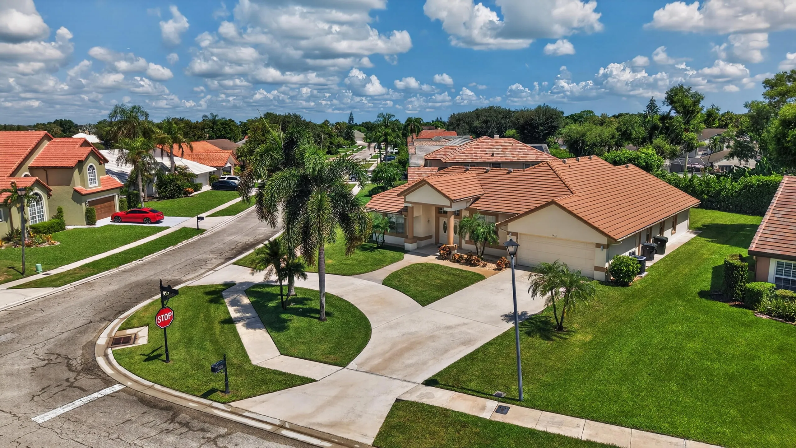 Mediterranean-inspired exterior with a tile roof, stucco finish, and an attached garage