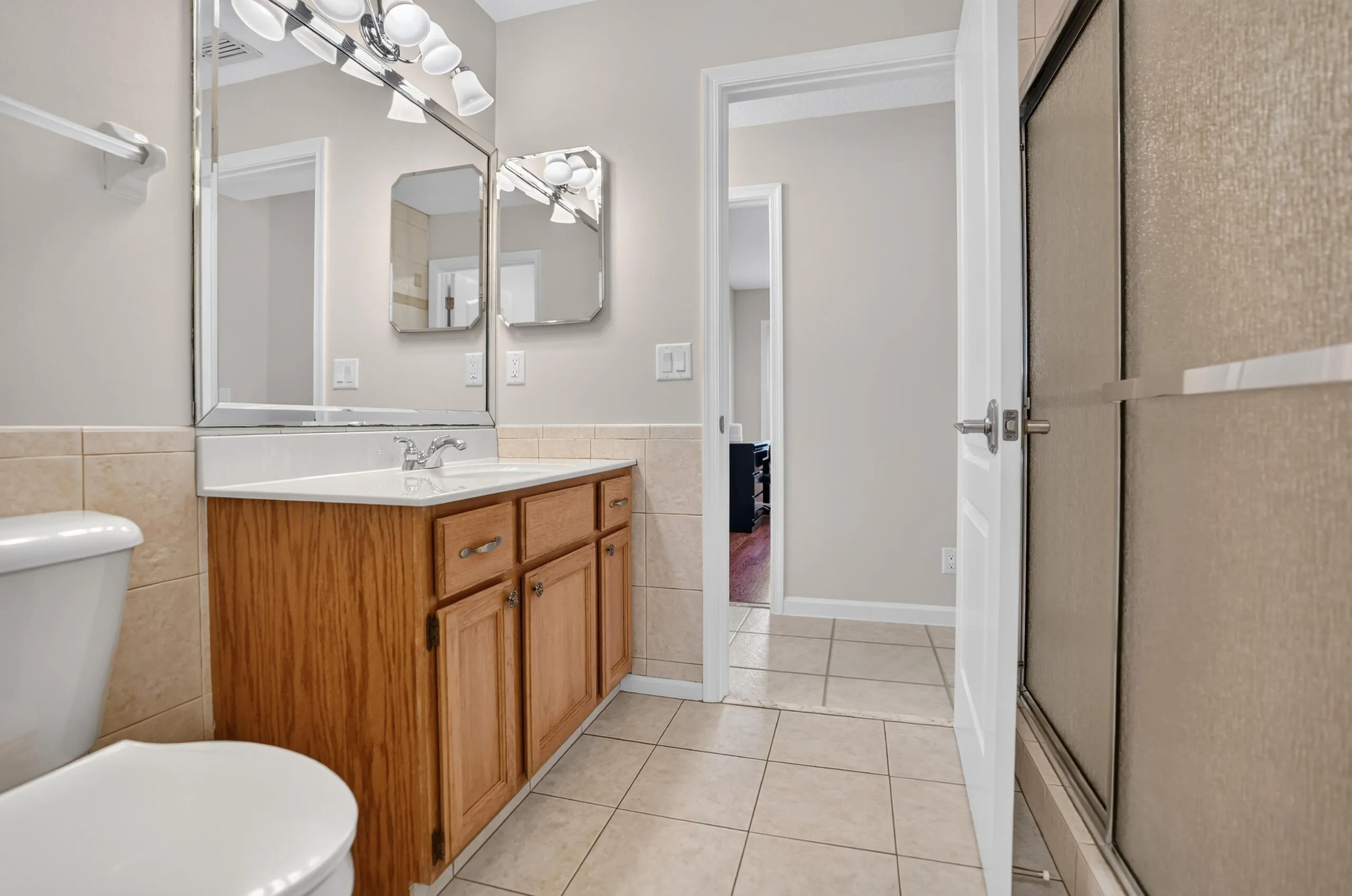 Wood-finish vanity with a white countertop and integrated sink