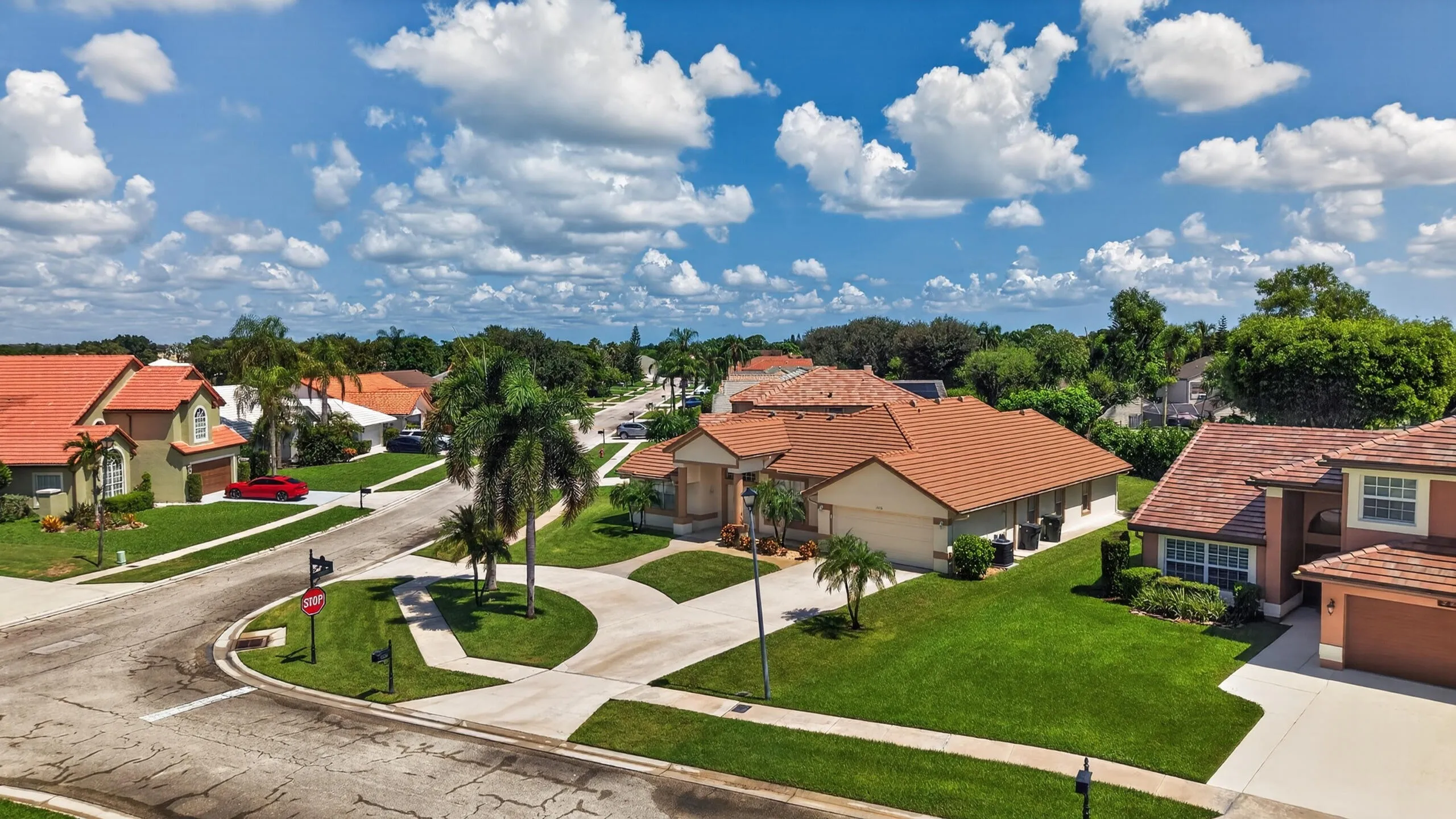Mediterranean-style architecture with a tile roof, stucco exterior, and attached garage