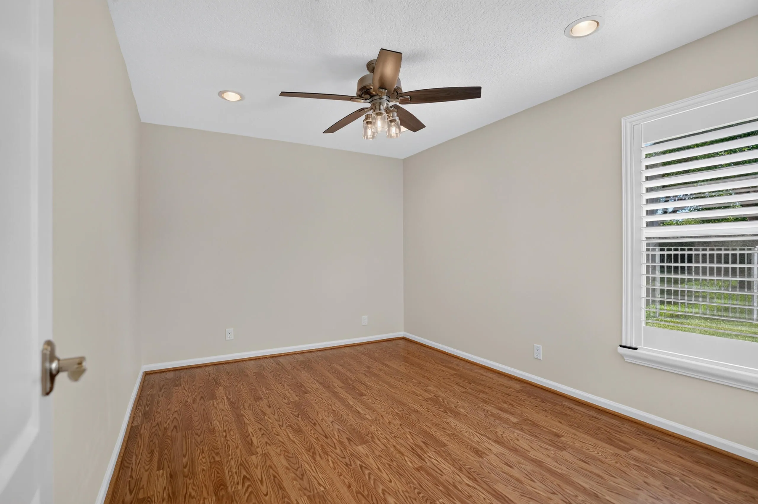 Wood-finish flooring, recessed lighting, ceiling fan with light kit, and a window with blinds