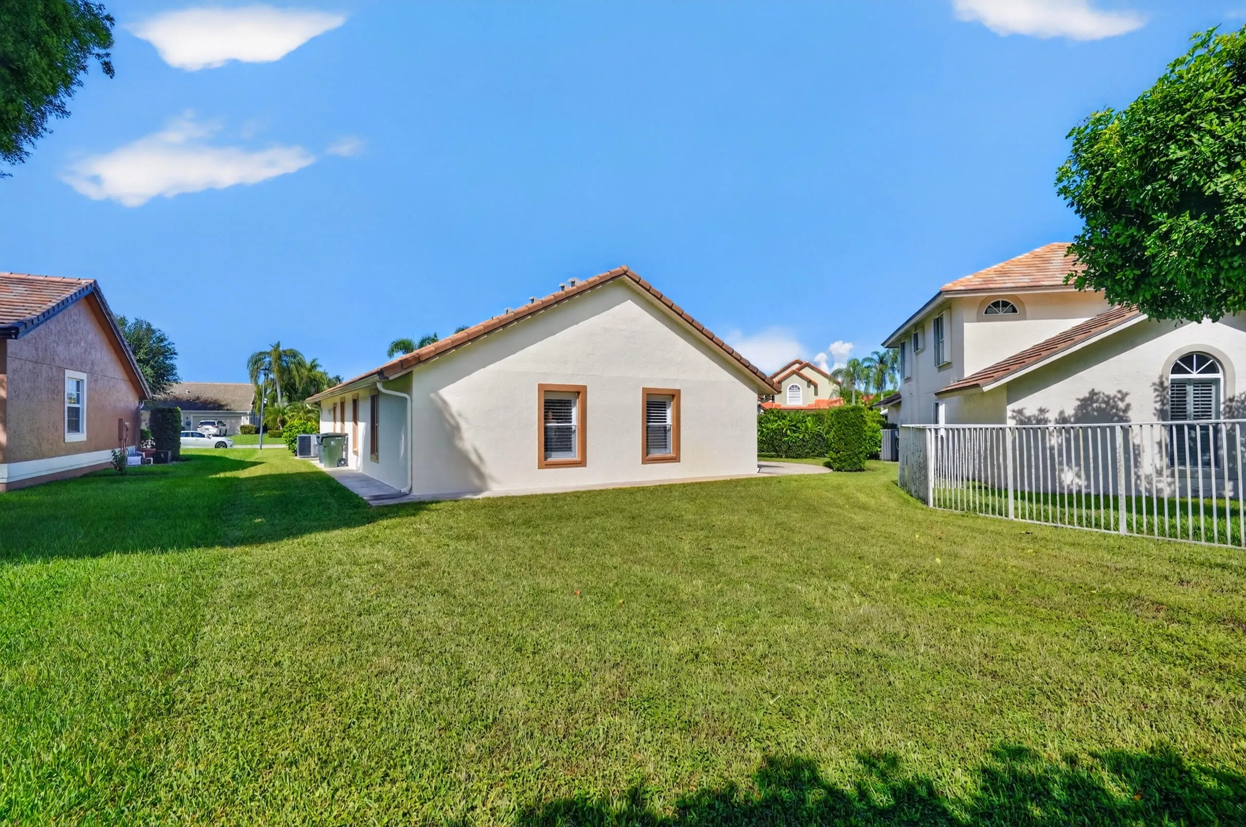 Expansive green lawn with mature landscaping