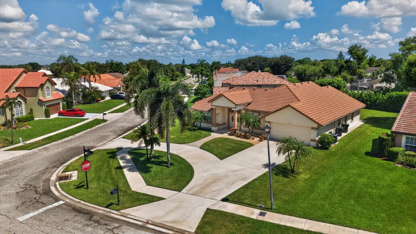 Mediterranean-inspired exterior with a tile roof, stucco finish, and an attached garage