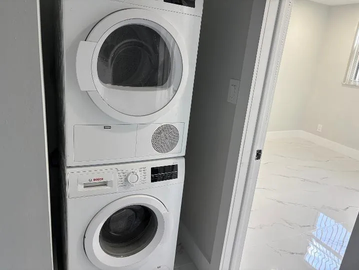 Stacked washer and dryer in unit