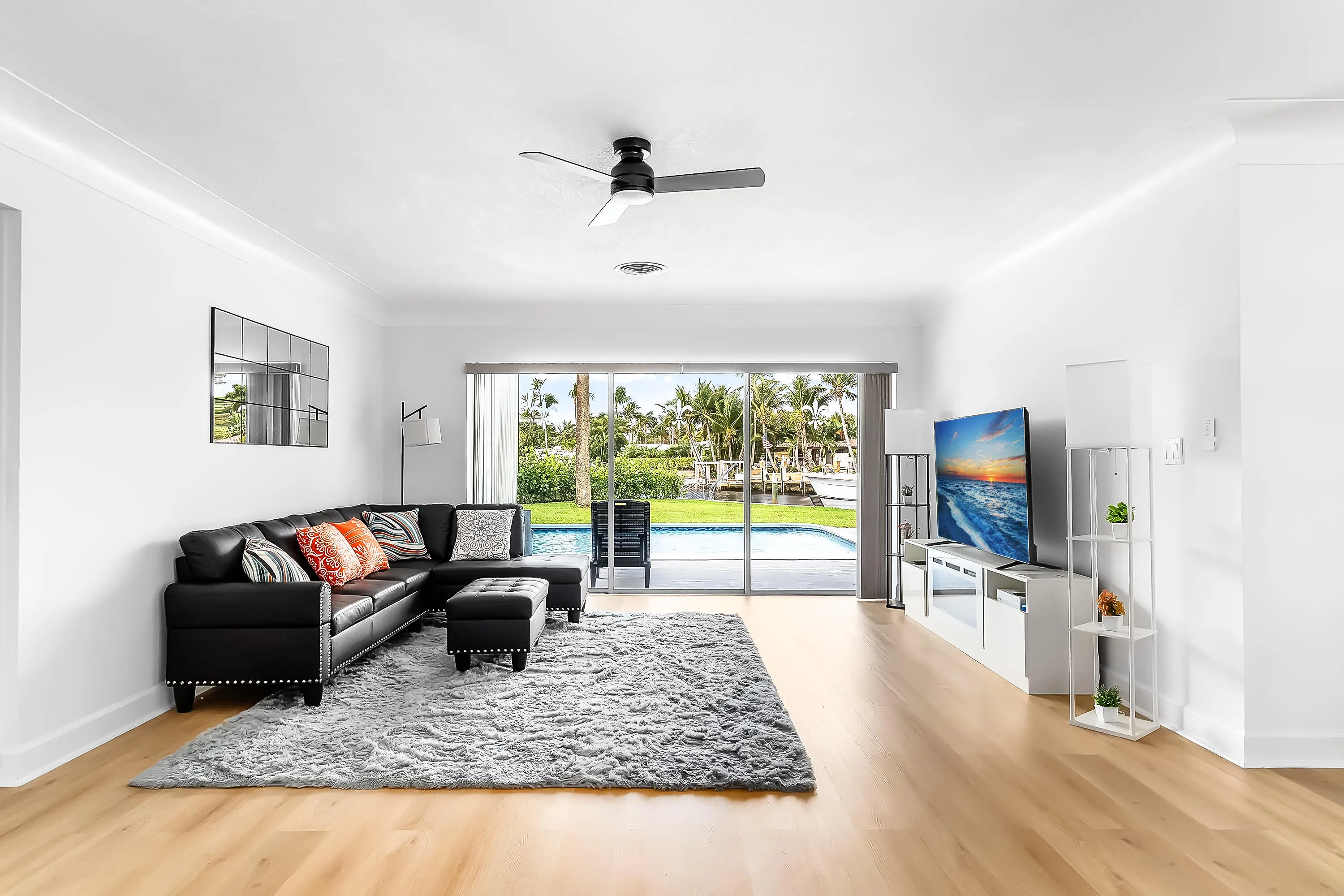 Bright interior space featuring wood-finish flooring, a contemporary ceiling fan, and recessed lighting
