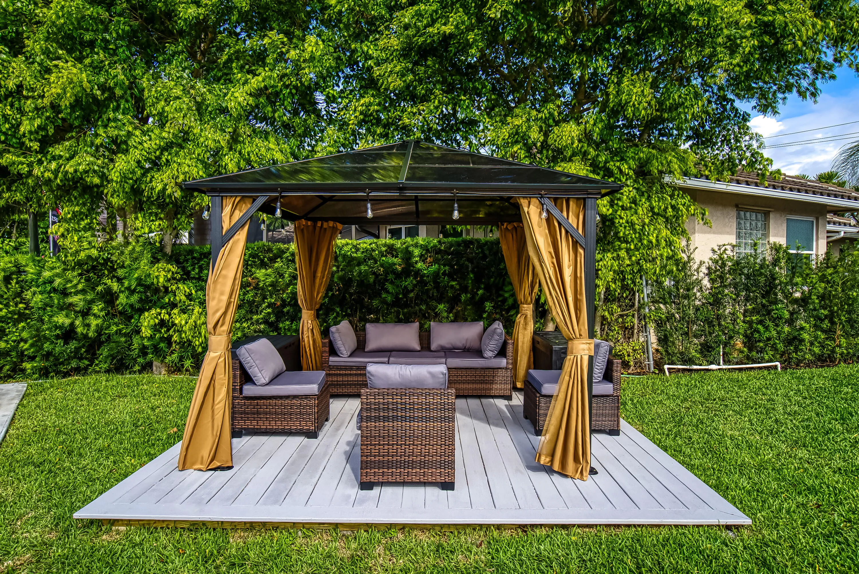Expansive backyard featuring a manicured lawn and a dedicated patio space
