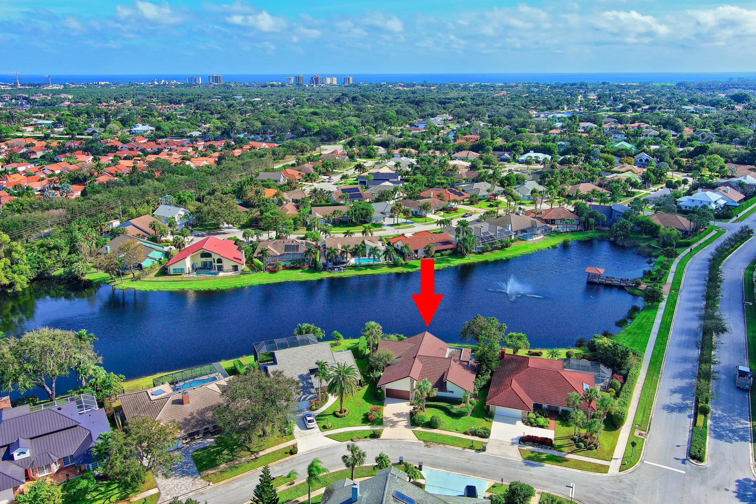 Waterfront property with mature landscaping and a private driveway