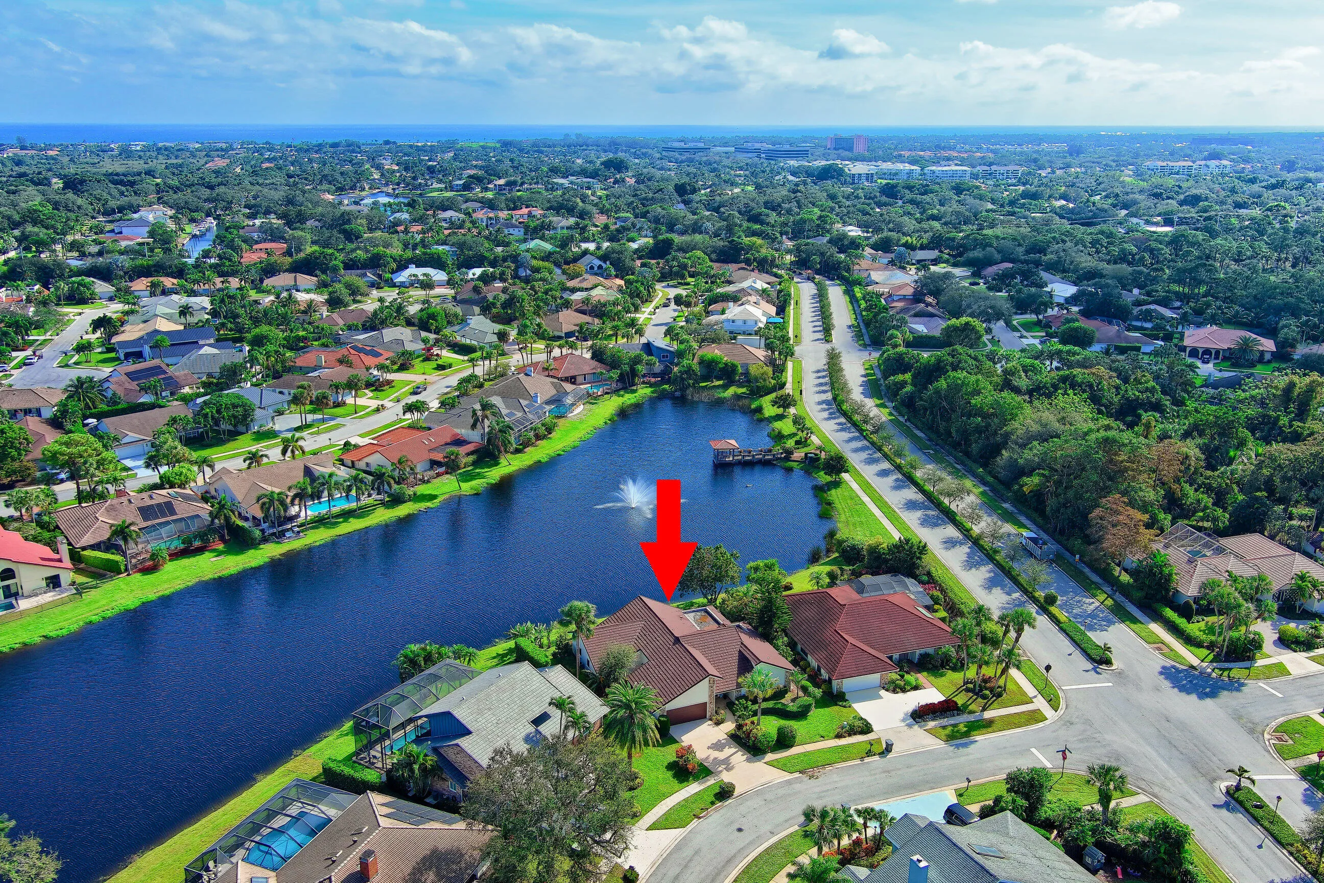 Waterfront property with mature landscaping and an attached garage