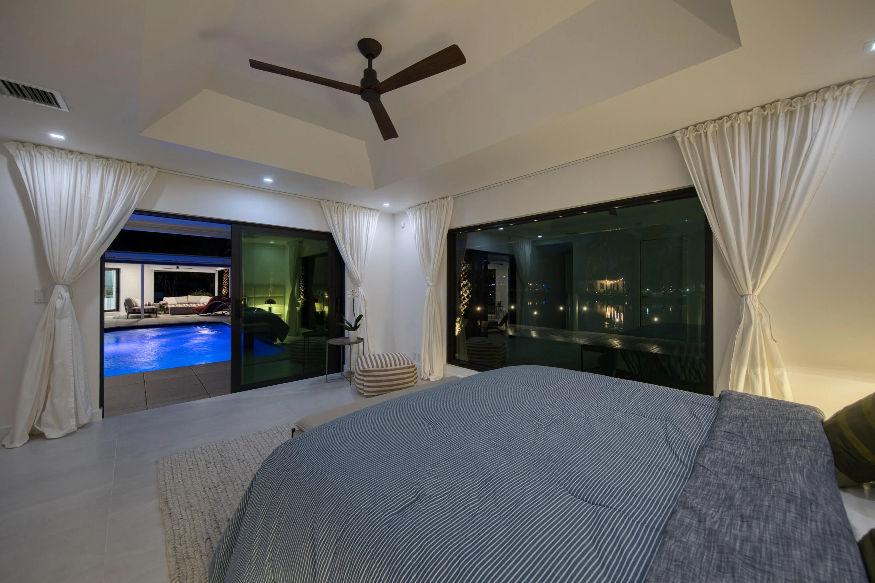 Night view from second primary bedroom overlooking pool and waterfront