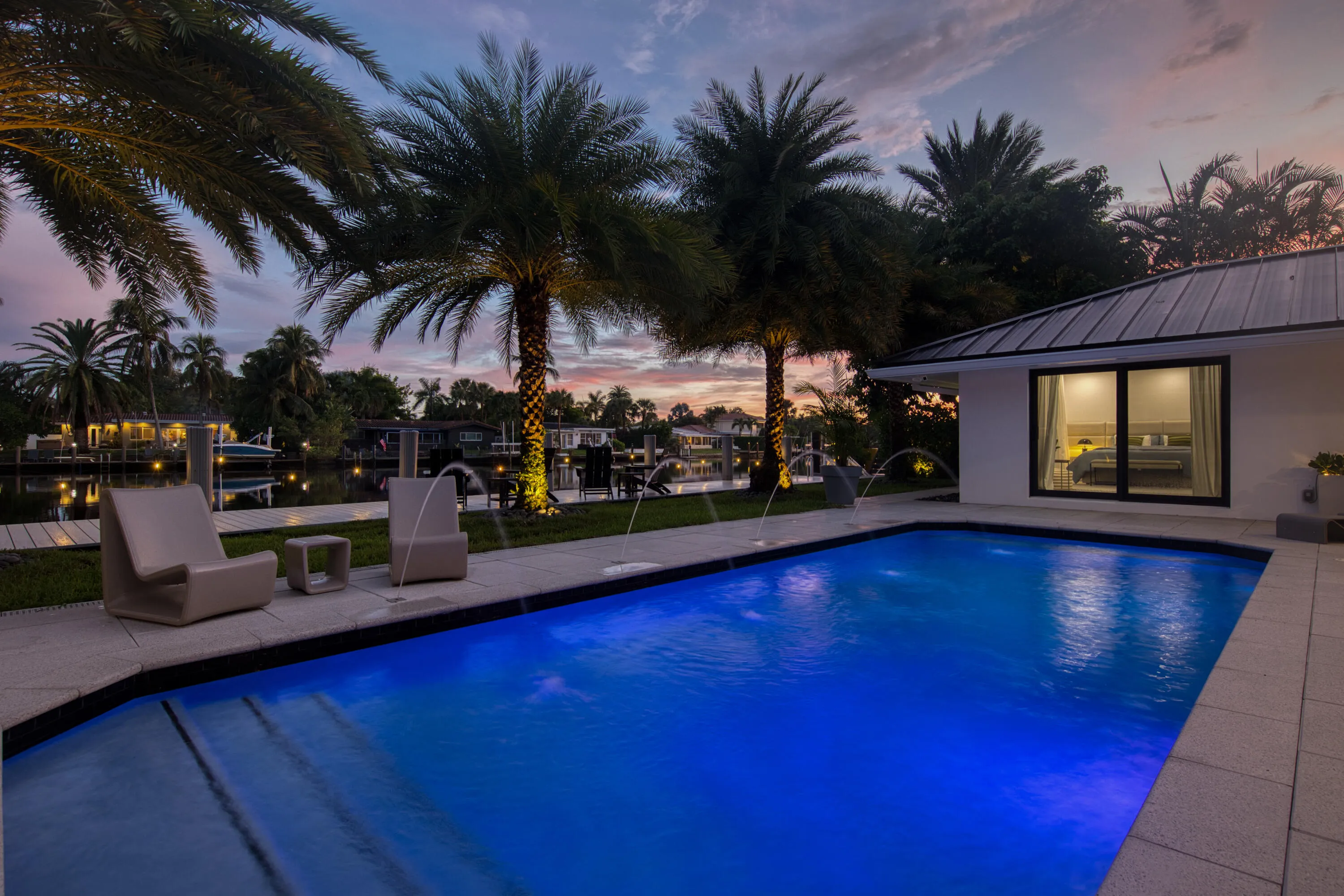 Pool at sunset with a view of the dock, and waterfront