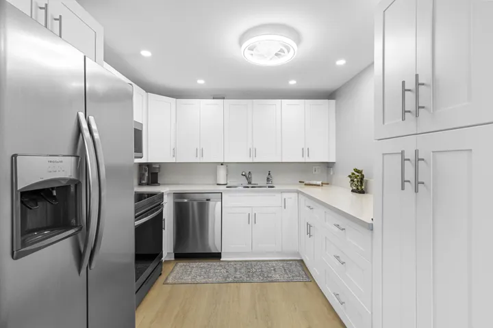 Remodeled kitchen with tailored kitchen cabinetry/ built-in storage