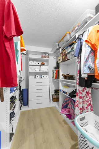 Walk in closet with custom wardrobe system