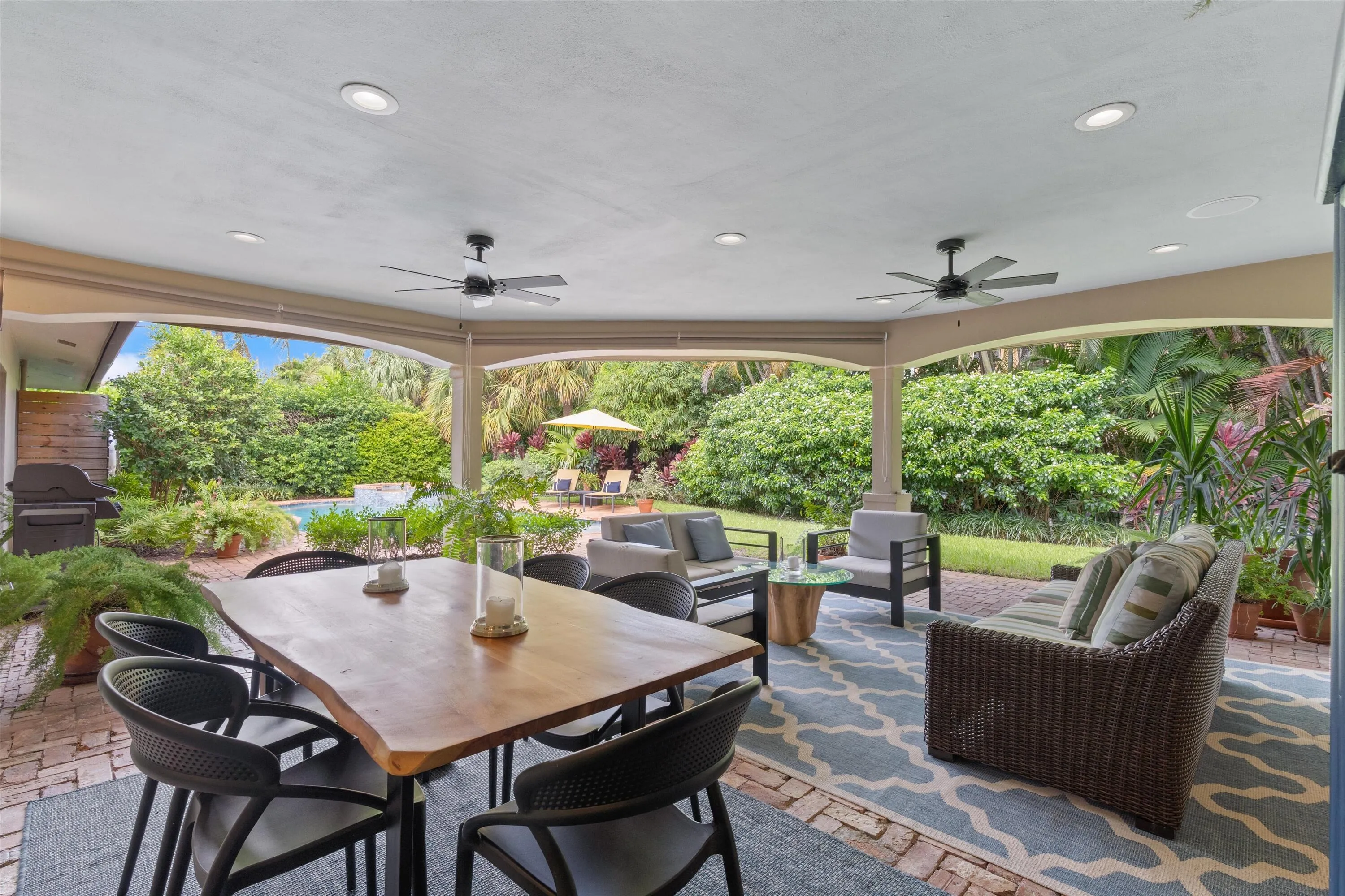 Expansive covered patio with recessed lighting and ceiling fans