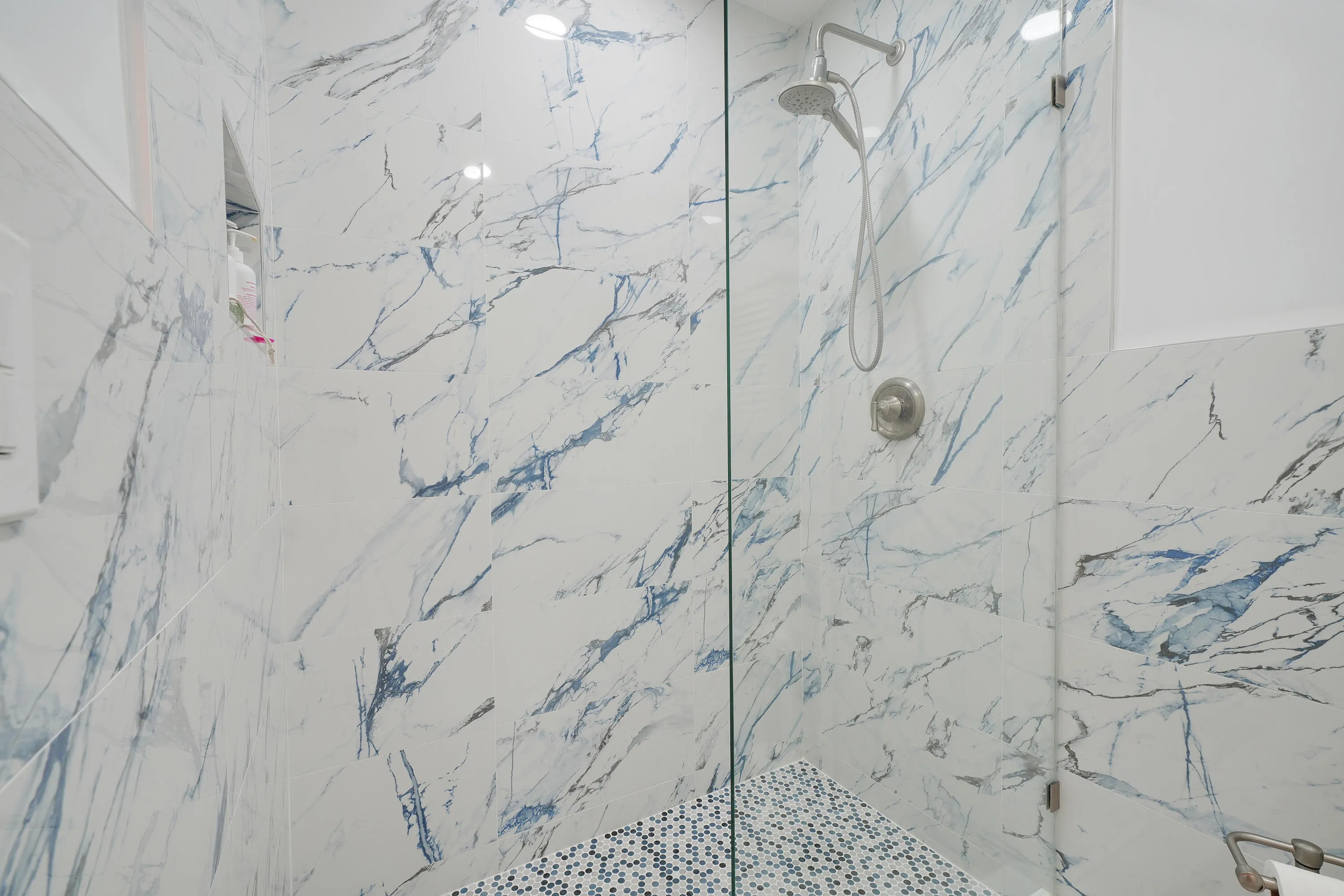 Gorgeous Calacatta Indigo frameless glass shower (MBR)