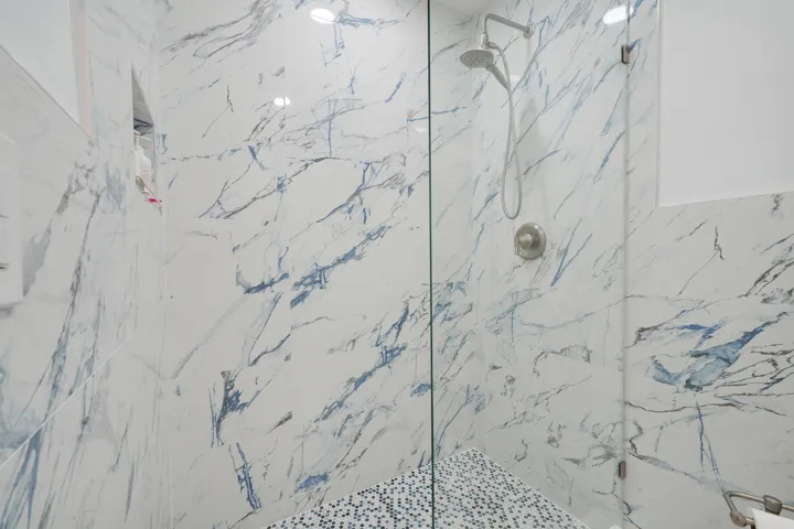 Gorgeous Calacatta Indigo frameless glass shower (MBR)