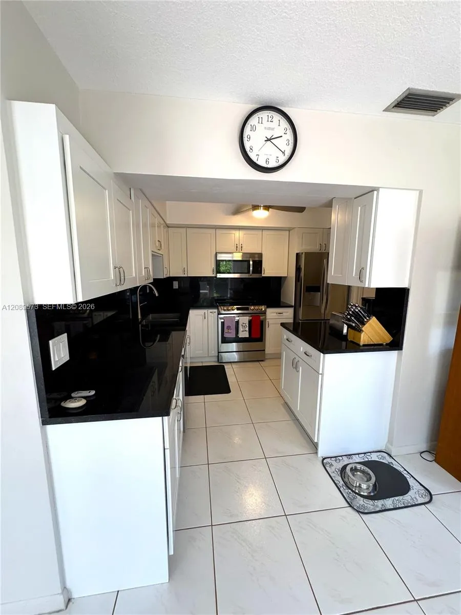 New kitchen with black granite counter tops, plus top of the line appliances - LG. Custom cabinets. Side door to garage.