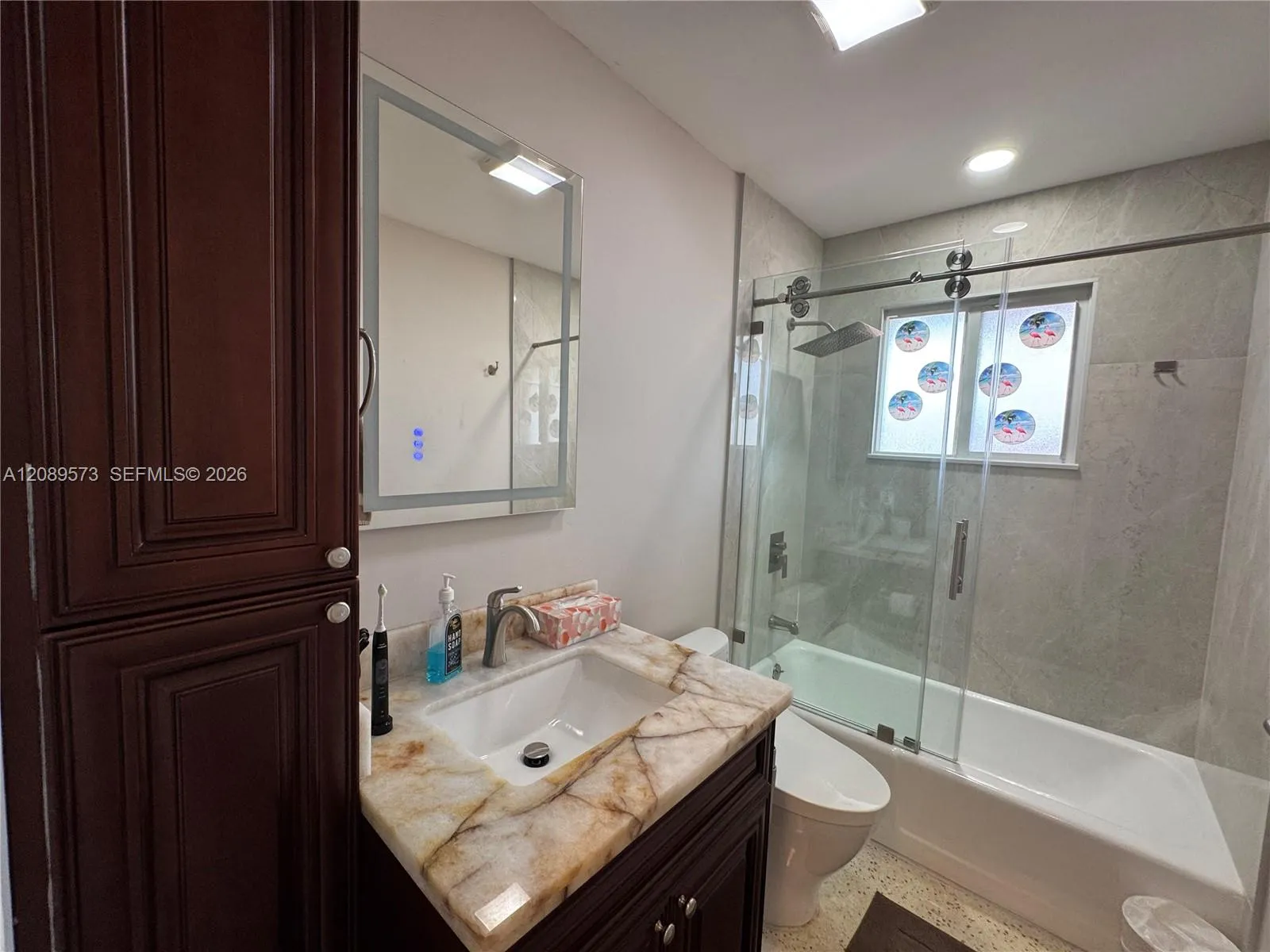 2nd Bathroom, custom shelving, marble top on vanity, beautiful tub/shower area with top of the line plumbing fixtures, plus Toto toilet.