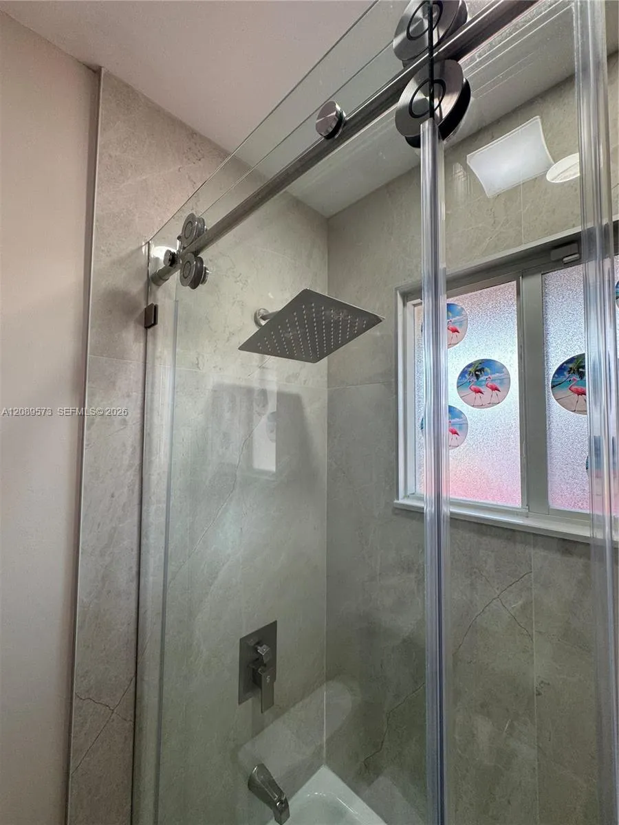 2nd Bathroom, custom shelving, marble top on vanity, beautiful tub/shower area with top of the line plumbing fixtures.