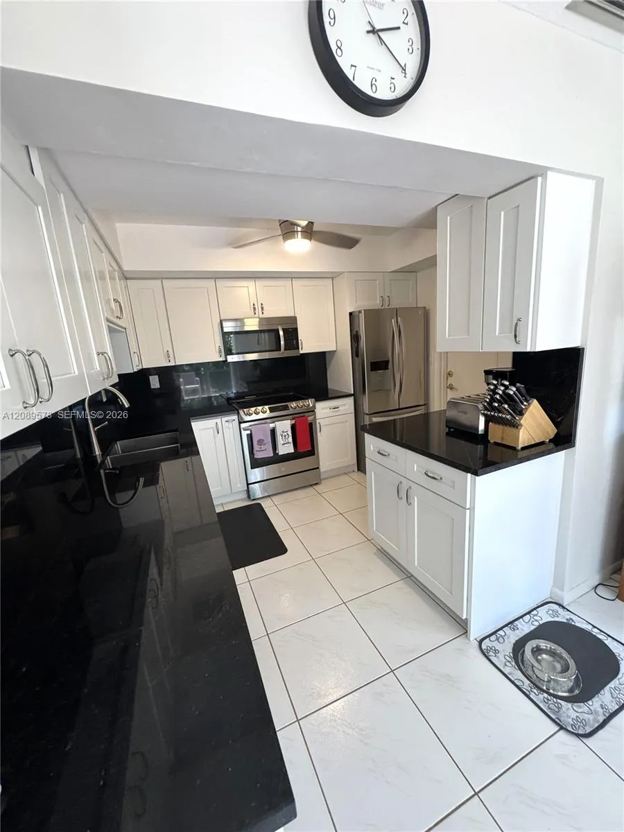 New kitchen with black granite counter tops, plus top of the line appliances - LG. Custom cabinets. Side door to garage.