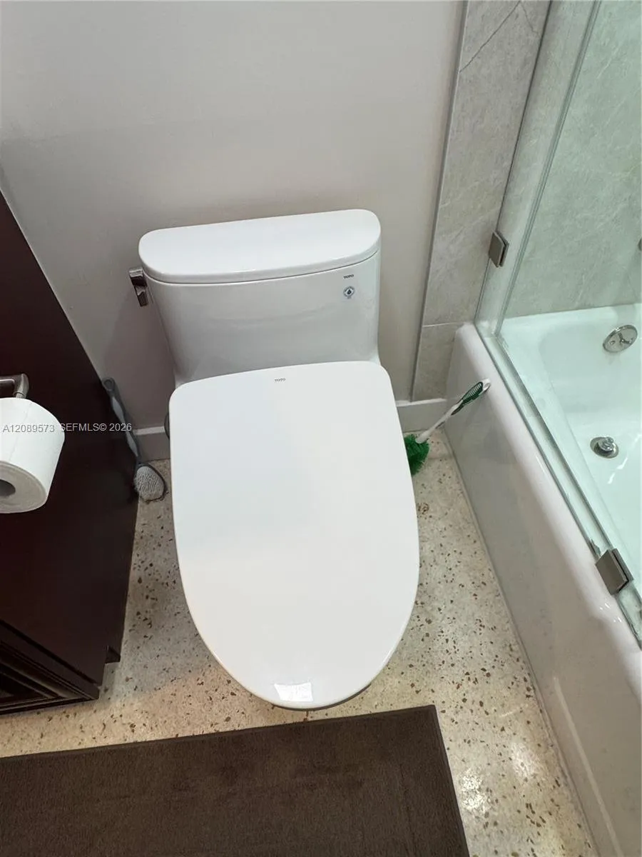 2nd Bathroom, custom shelving, marble top on vanity, beautiful tub/shower area with top of the line plumbing fixtures, plus Toto toilet.