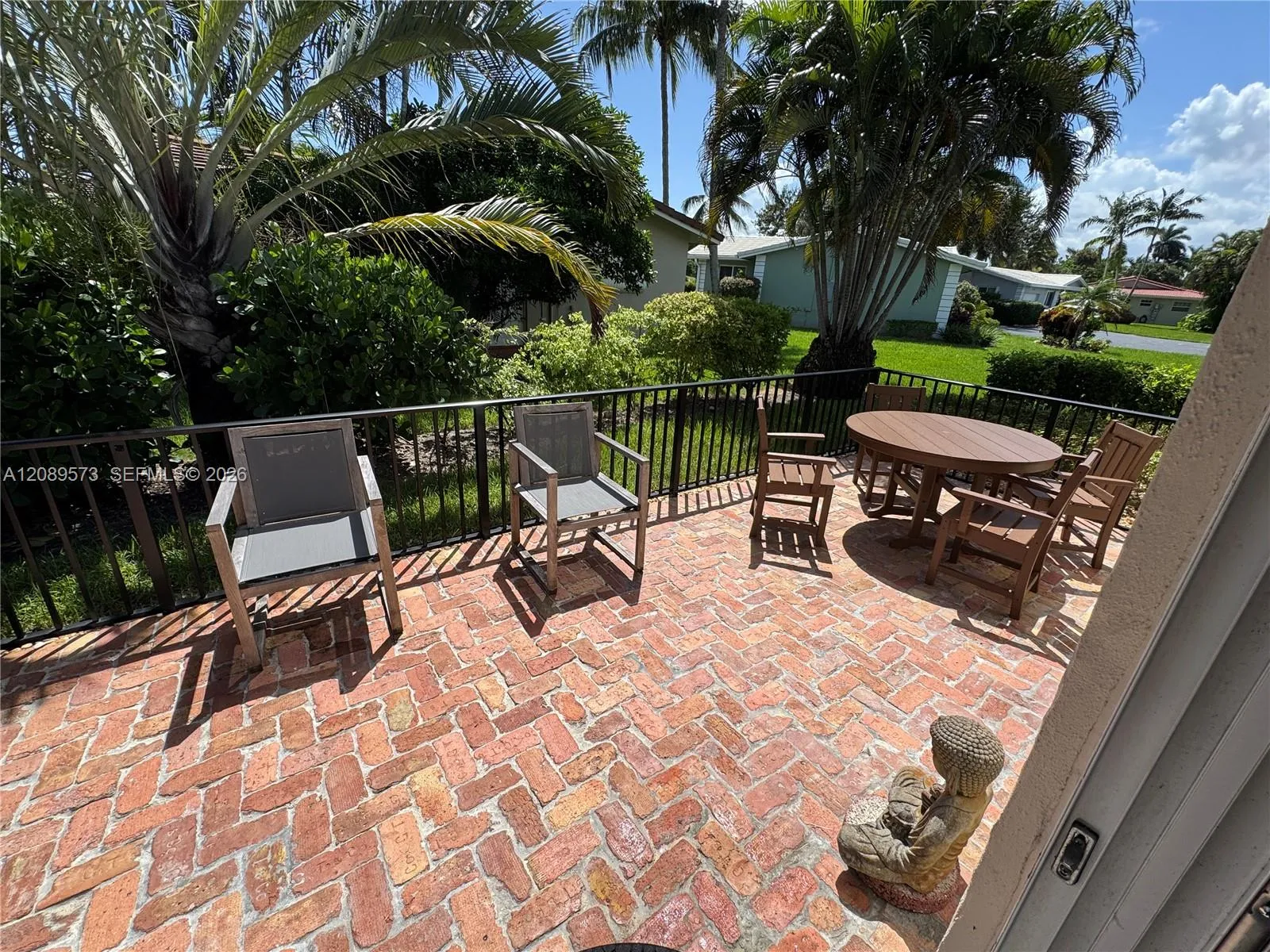 Beautiful brick patio with decorative railing.