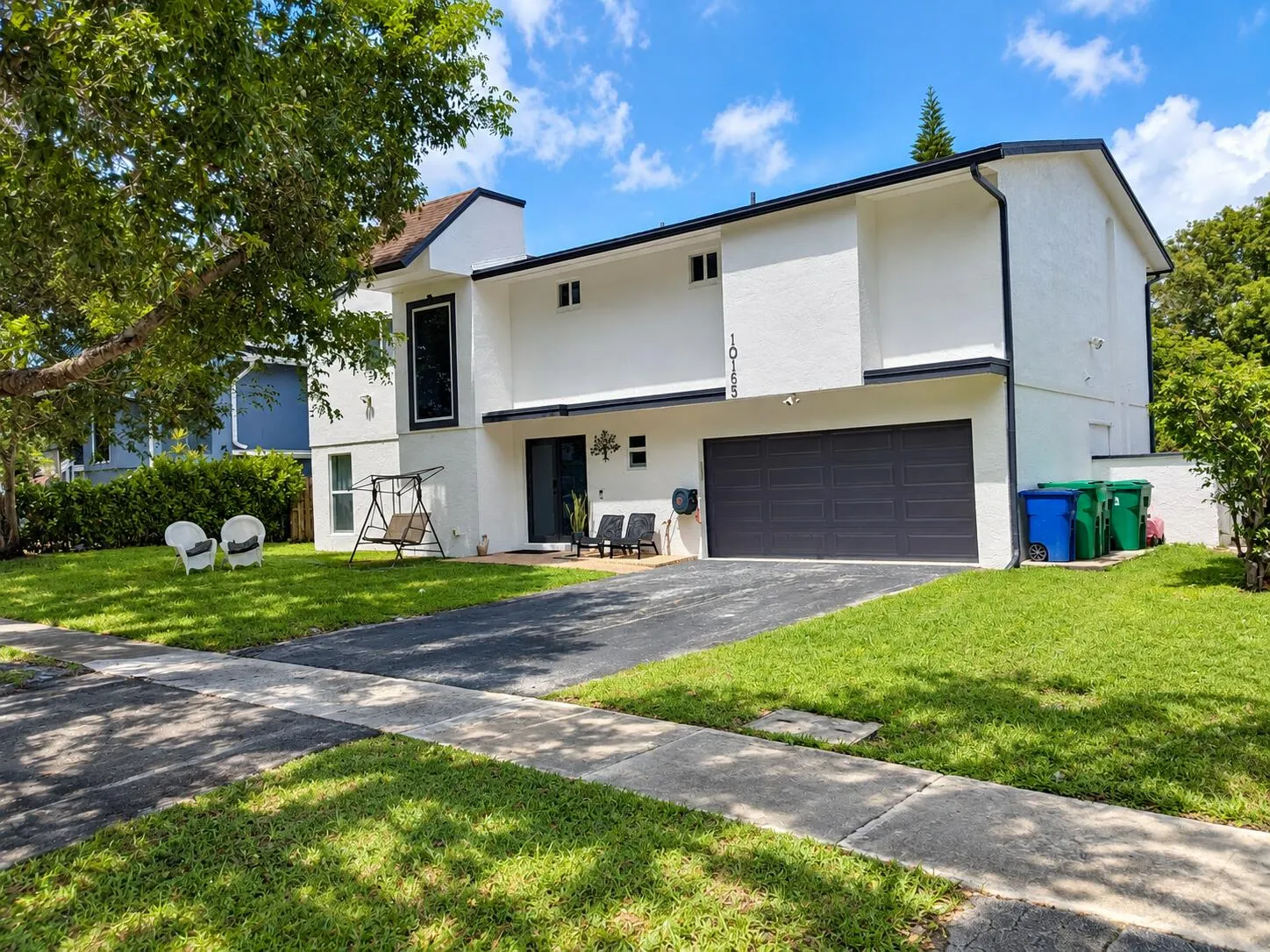 Contemporary exterior with a white stucco finish and black trim
