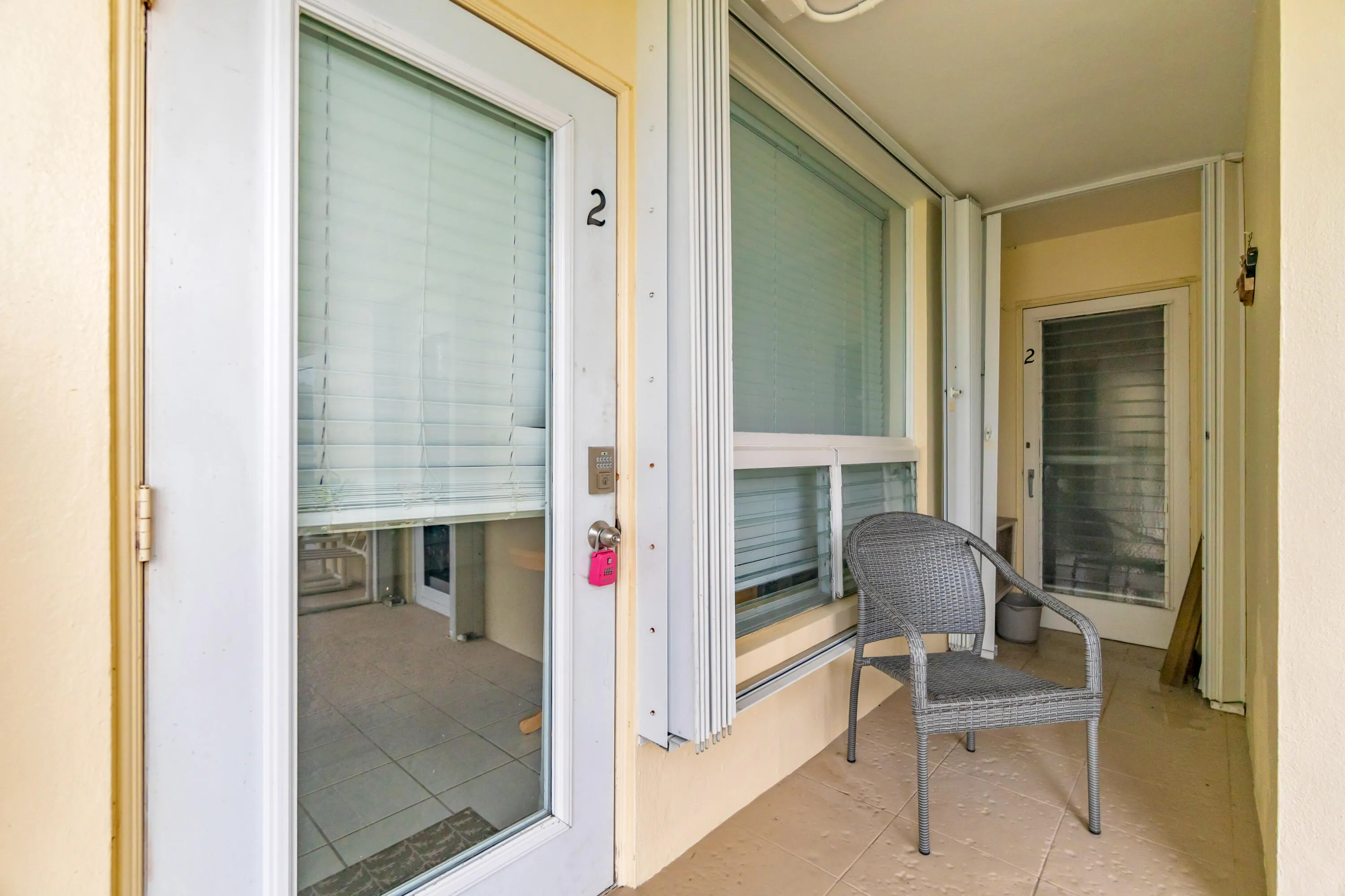 Covered outdoor entry with a full-light entry door, fixed window, and tile flooring
