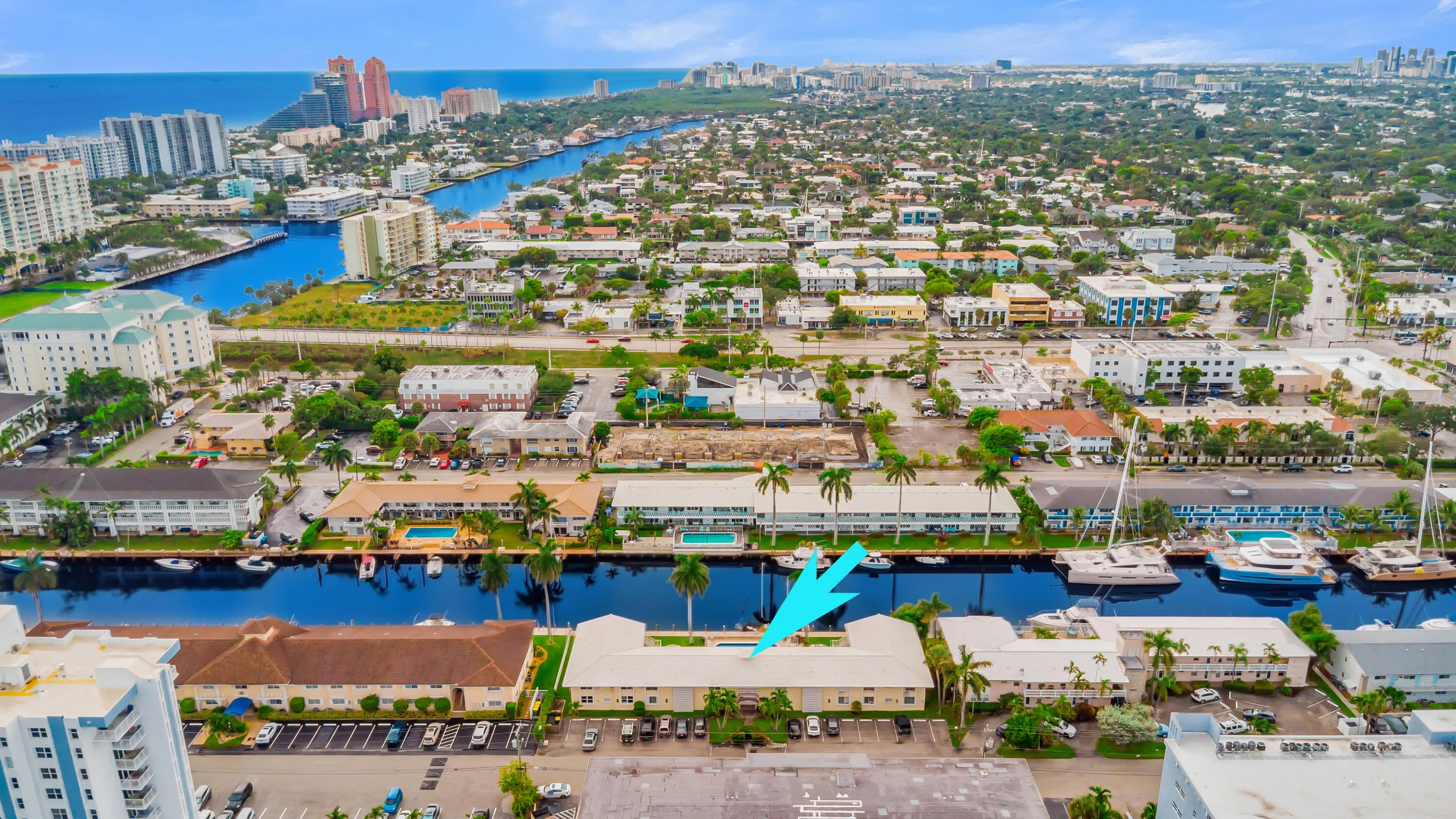 Waterfront property with direct canal access, surrounded by urban amenities and distant ocean views