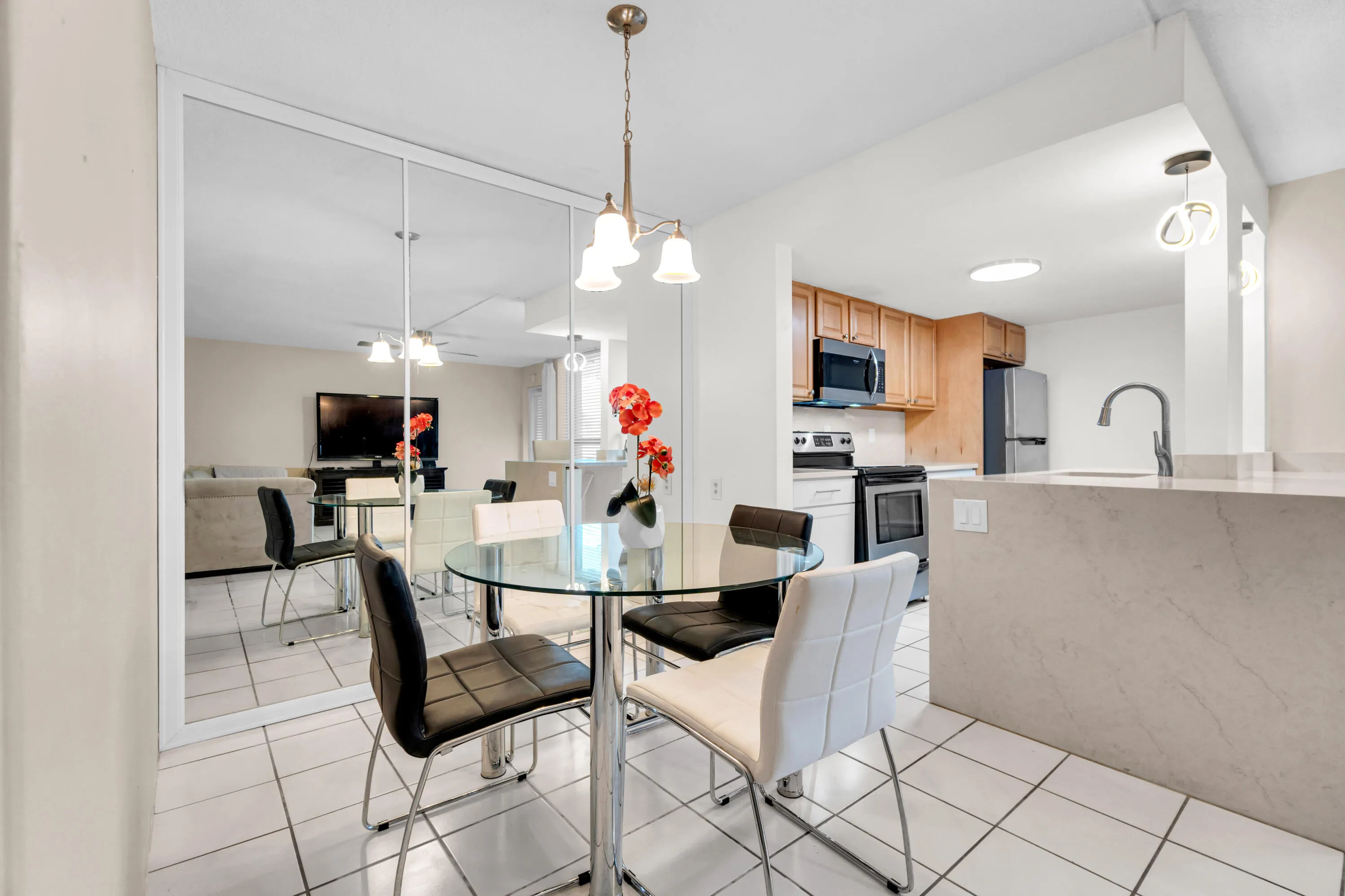 Kitchen featuring wood cabinetry, stainless steel appliances, and a breakfast bar with stone-finish countertops