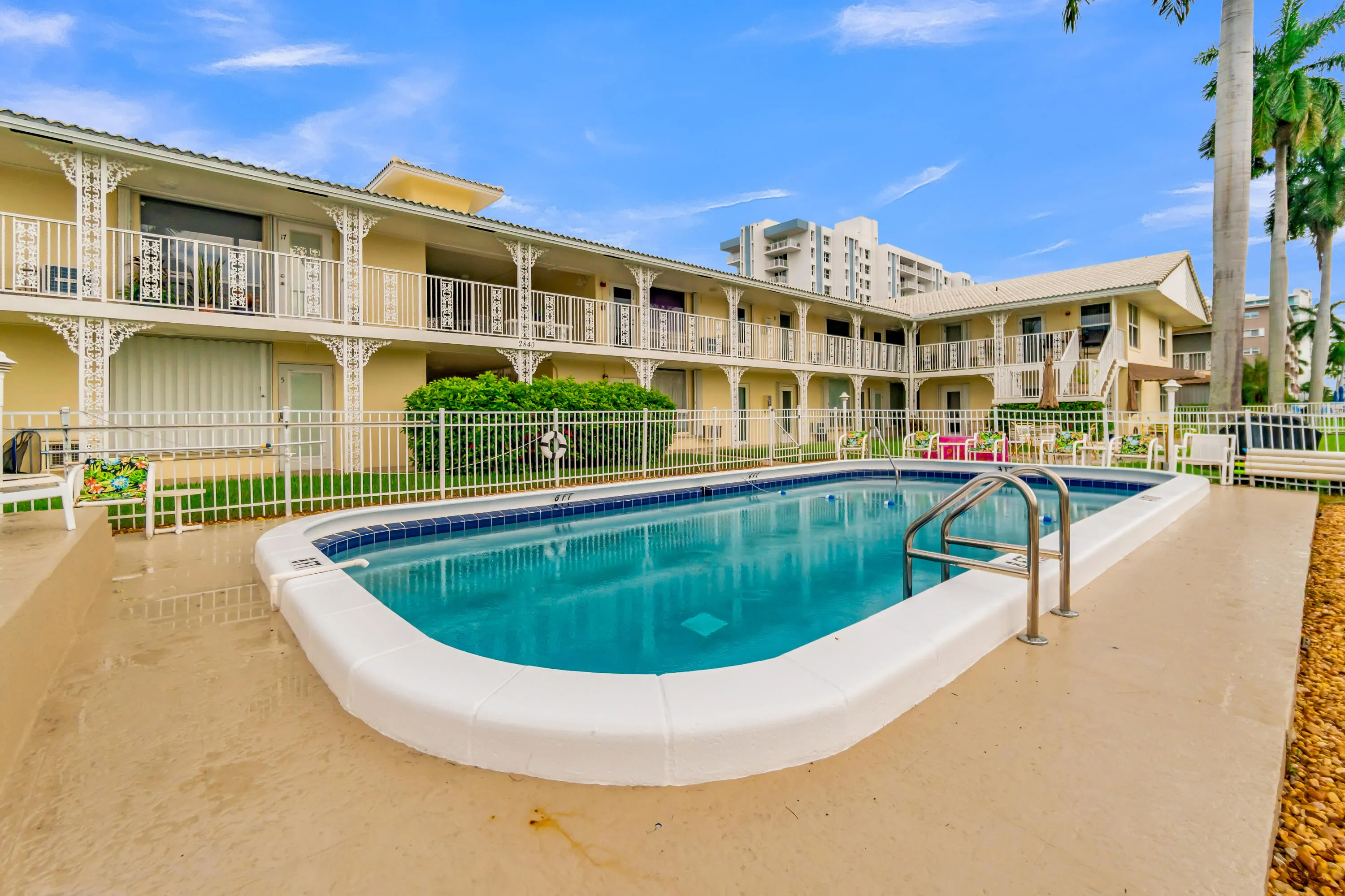 Rectangular swimming pool with integrated steps and a surrounding concrete deck