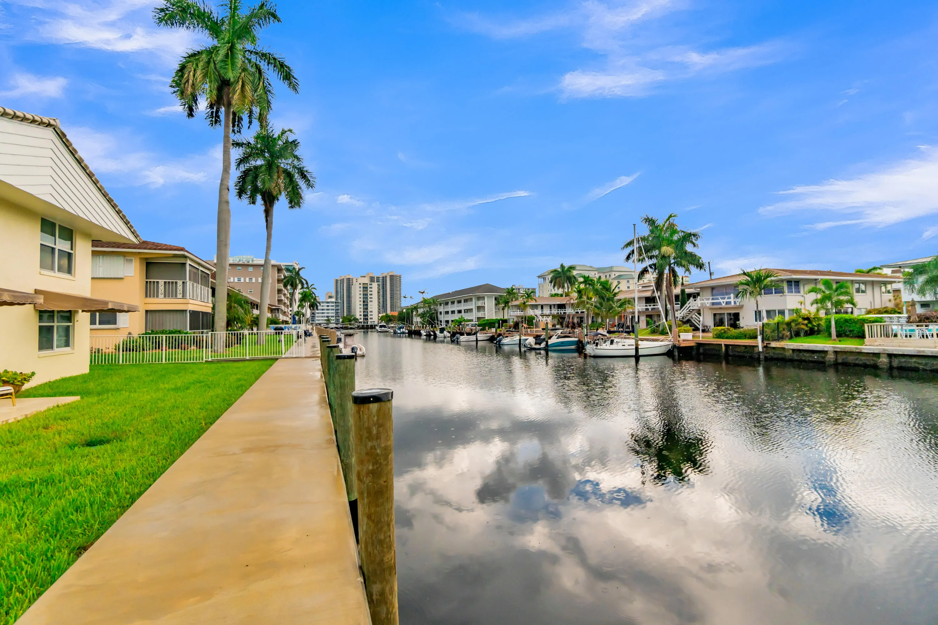 Waterfront property with a private dock and mature palm trees