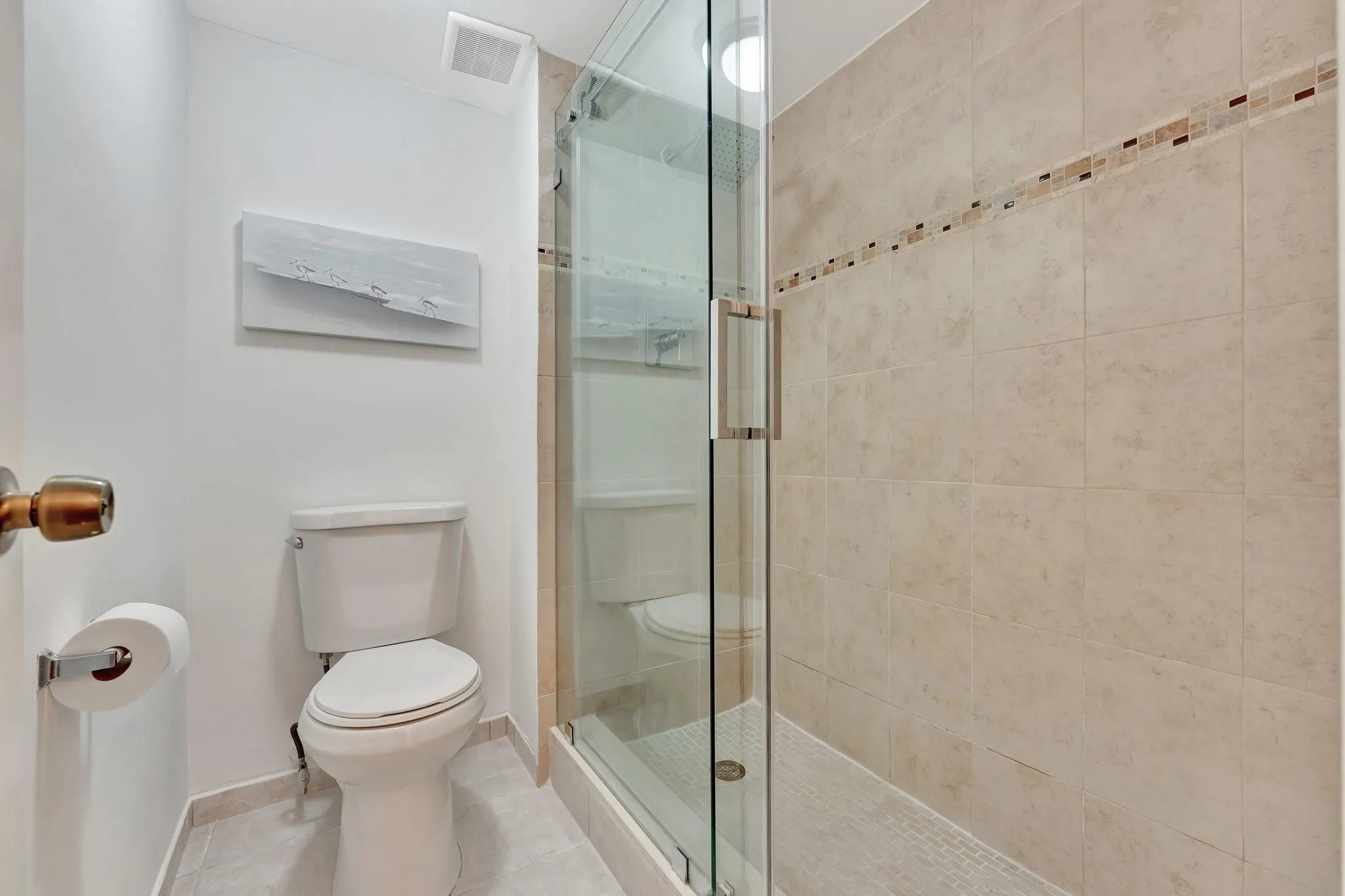 Separate private toilet and shower with seamless glass shower door