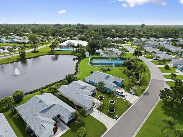 Community amenities featuring a central pond, tennis courts, and a swimming pool