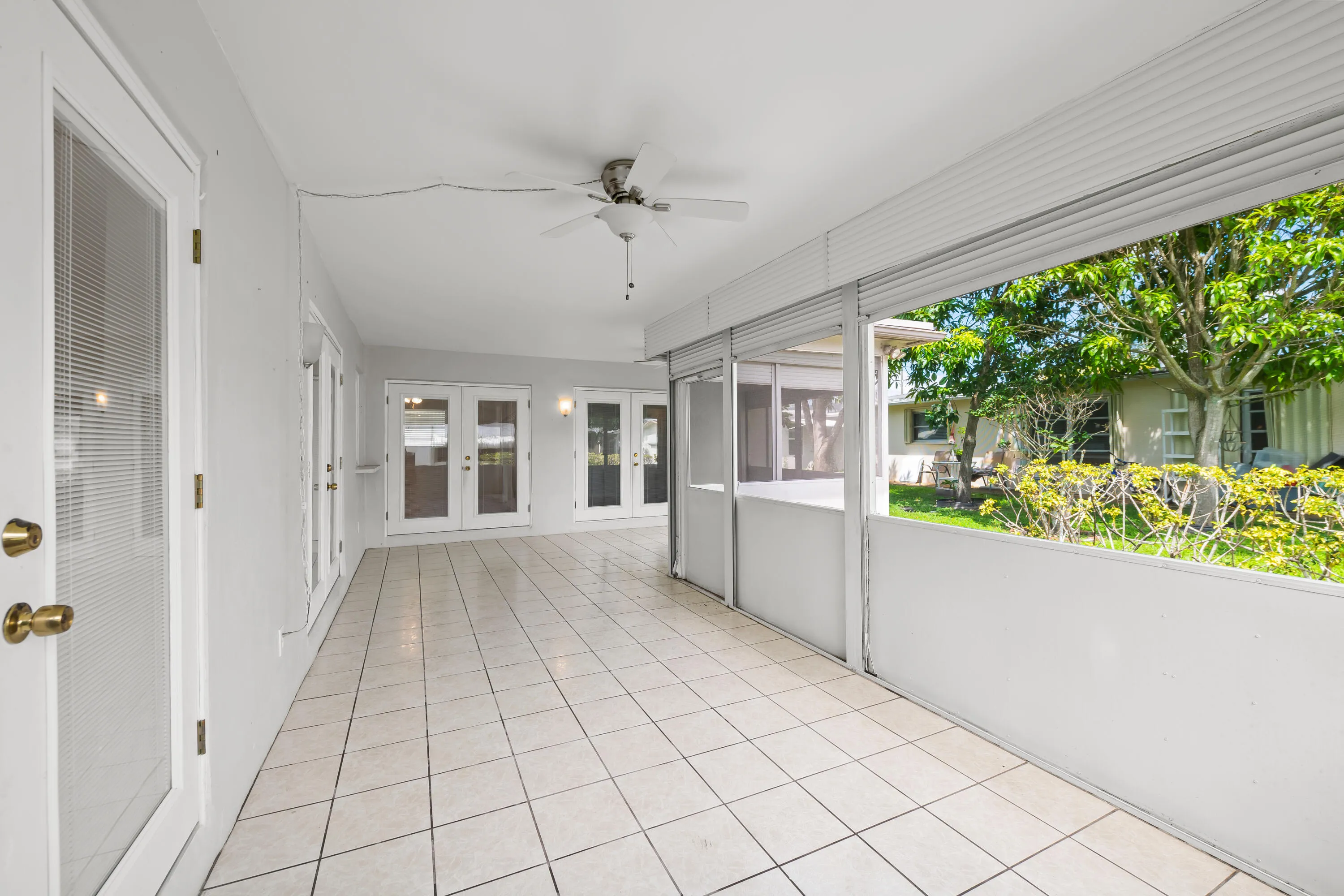 Screened in Back Patio with rolling shutters and newer updated hardware.