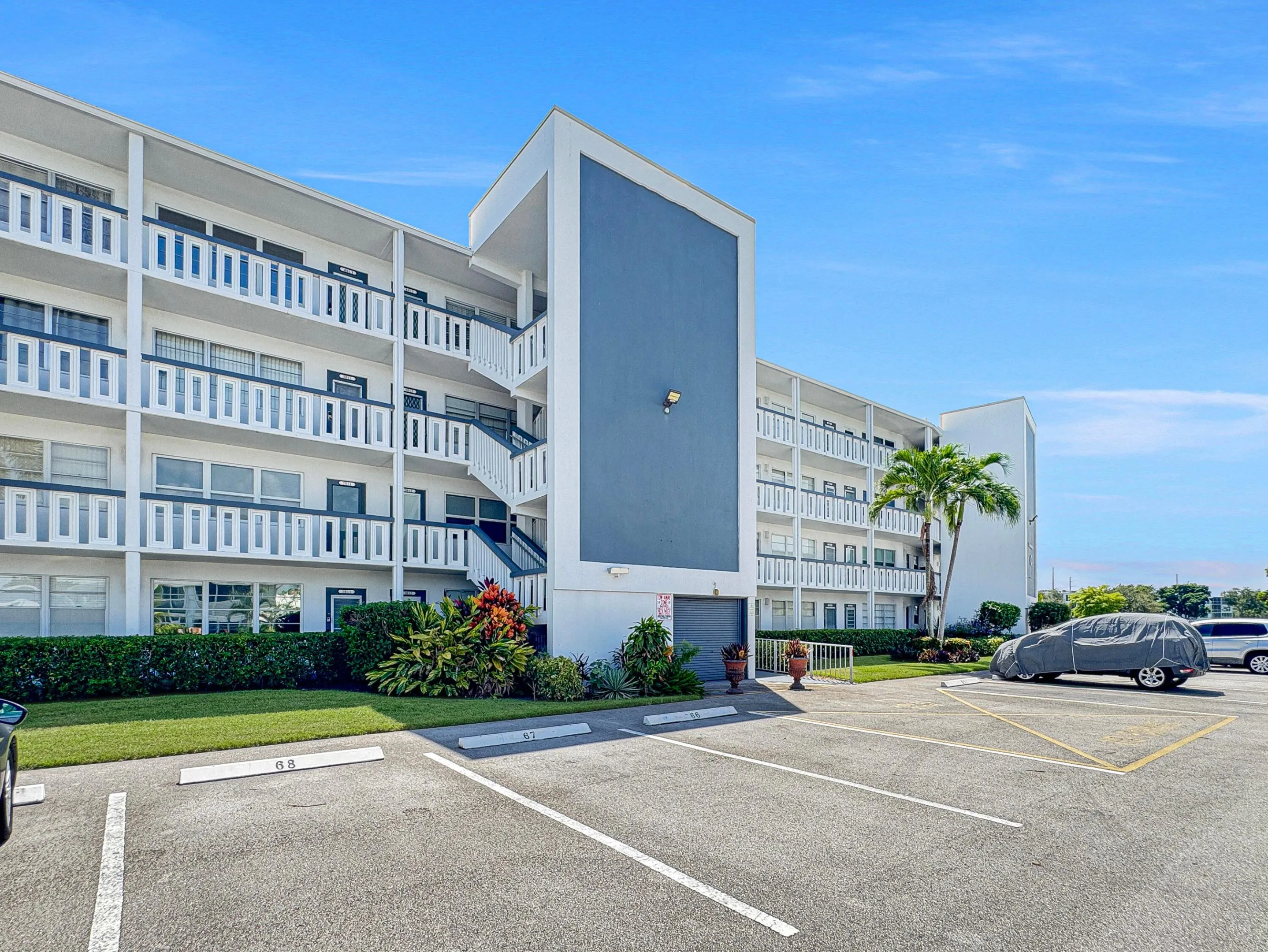 Multi-story residential building with private balconies and exterior stairwells