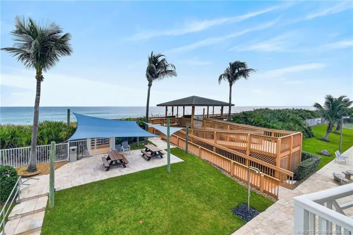 Private beach access with an oceanfront pavilion and seating area overlooking the Atlantic.