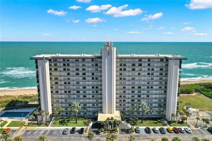 Aerial view of Island Crest with the Atlantic Ocean and beachfront directly behind the building.