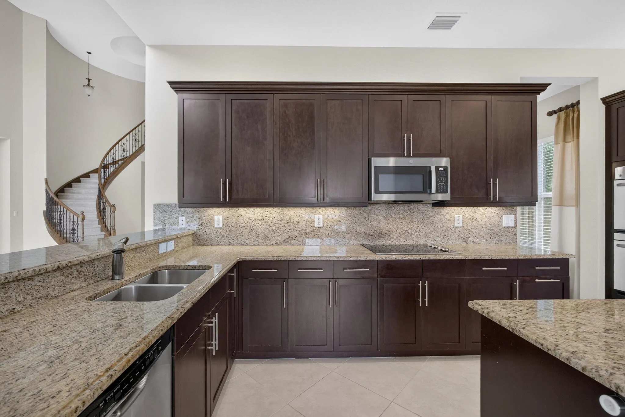 Kitchen features under and over counter lighting, crown ,moldings, double oven and SS appliances