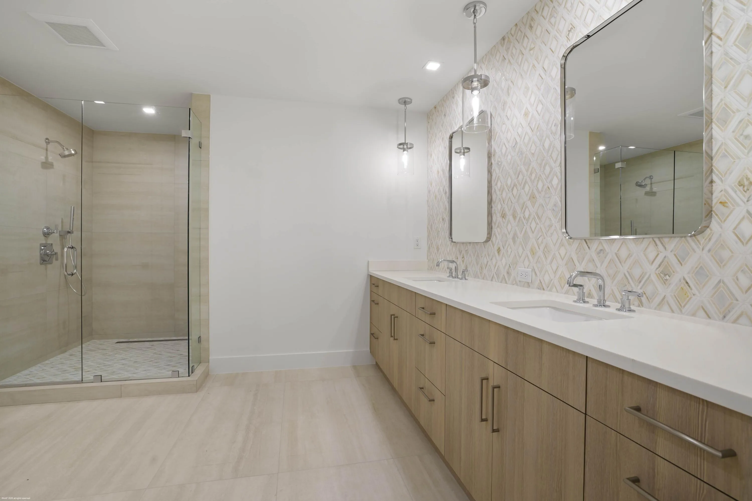 Dual vanity with undermount sinks, wood-finish cabinetry, and white countertops