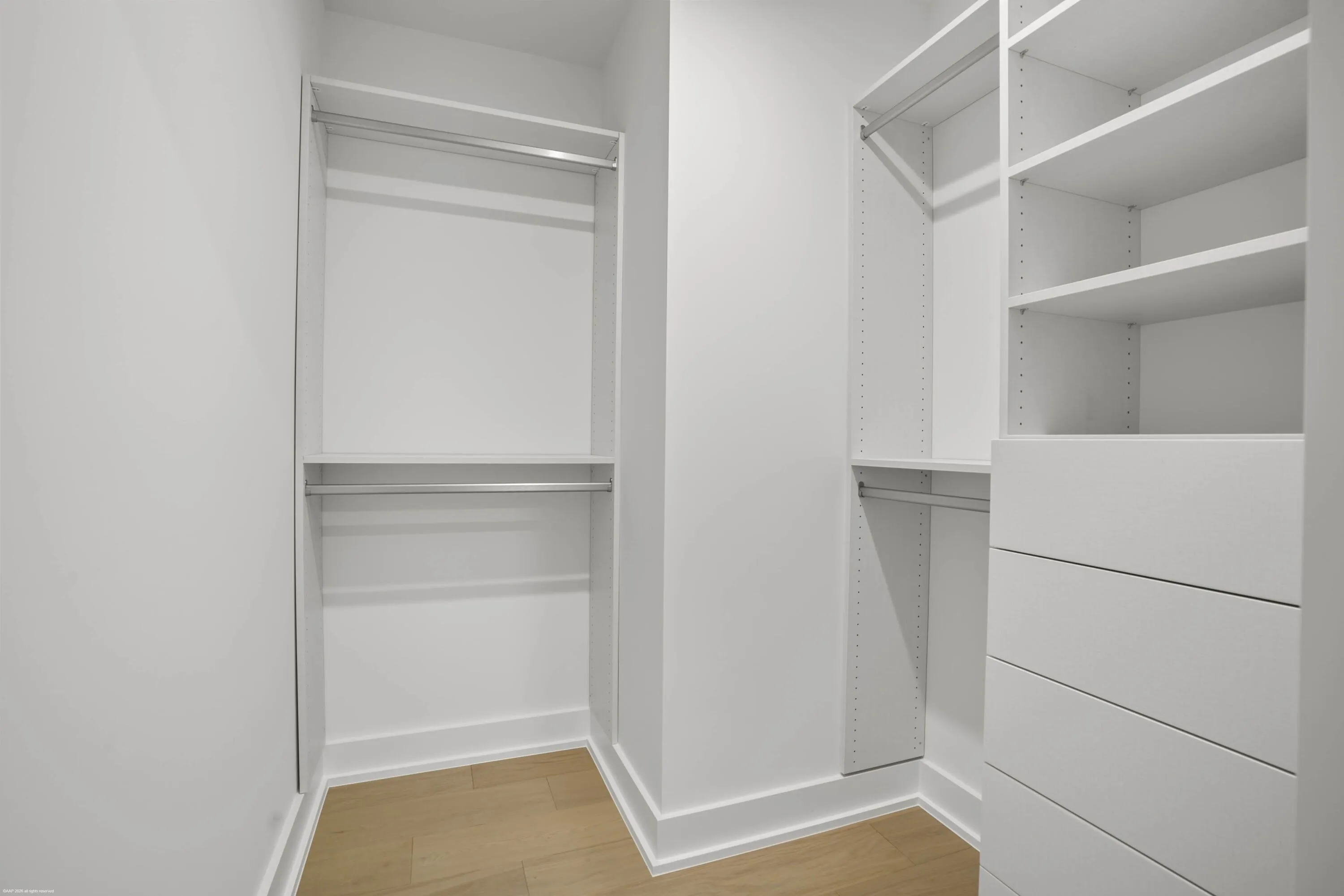 Built-in closet system featuring shelving, hanging rods, and integrated drawers