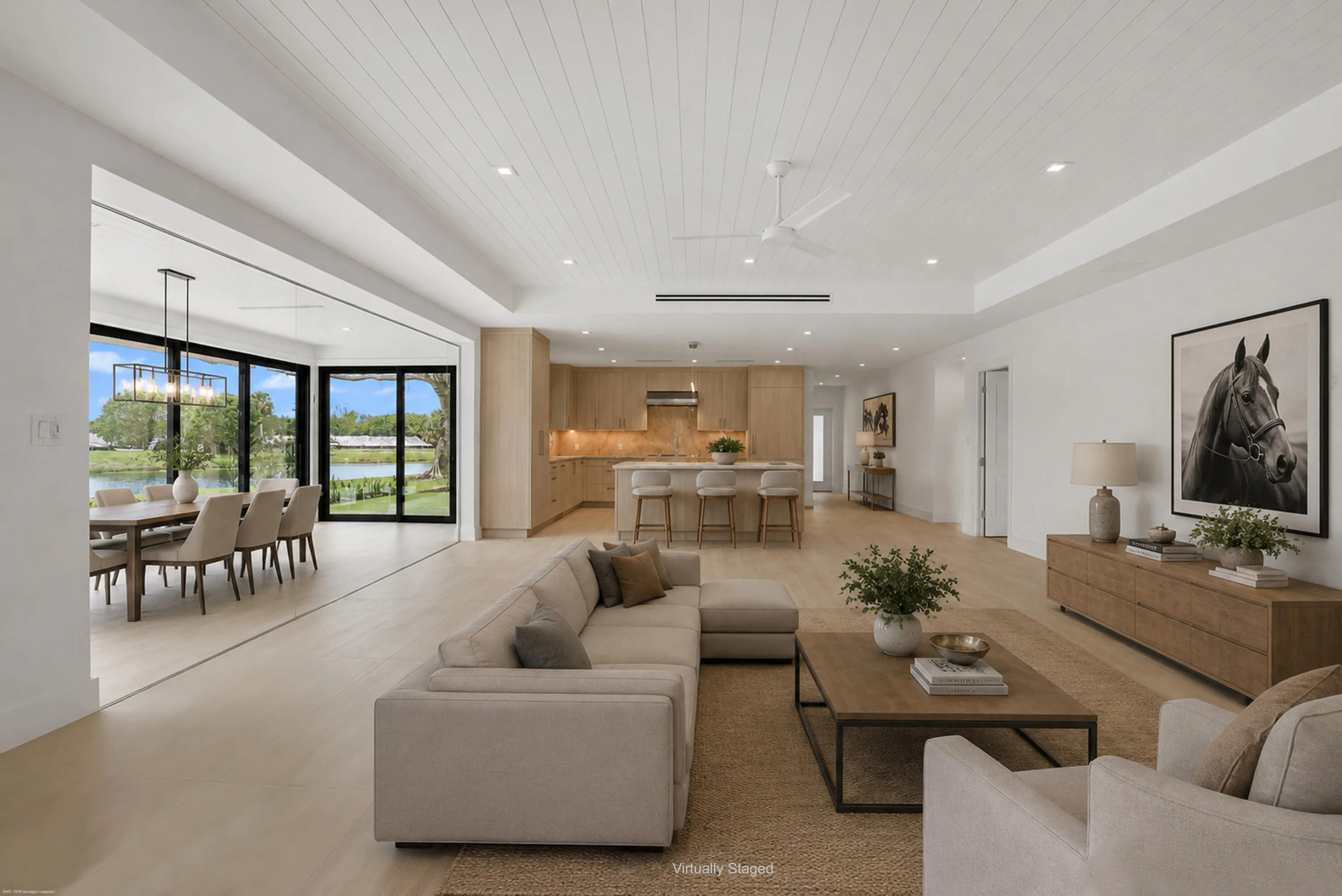 Open-concept living area with light wood-finish flooring, white shiplap ceiling, and recessed lighting