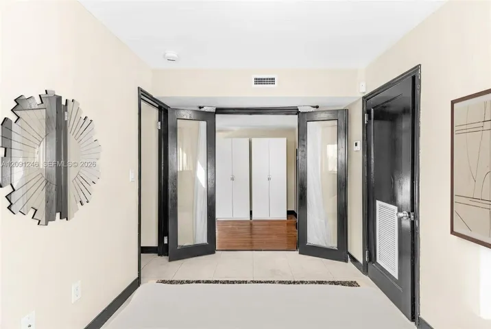 second bedroom with doors opening to living area