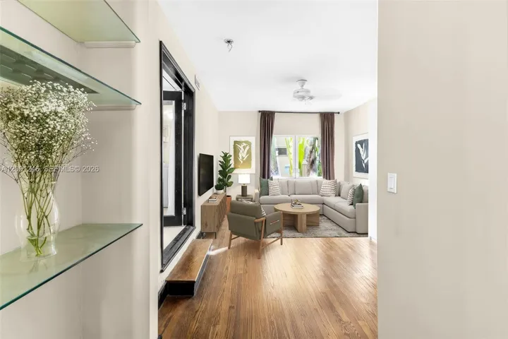passageway to living area with built in shelving