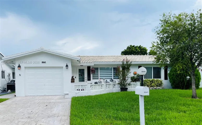 FRONT OF HOME W/ STAMP DRIVEWAY